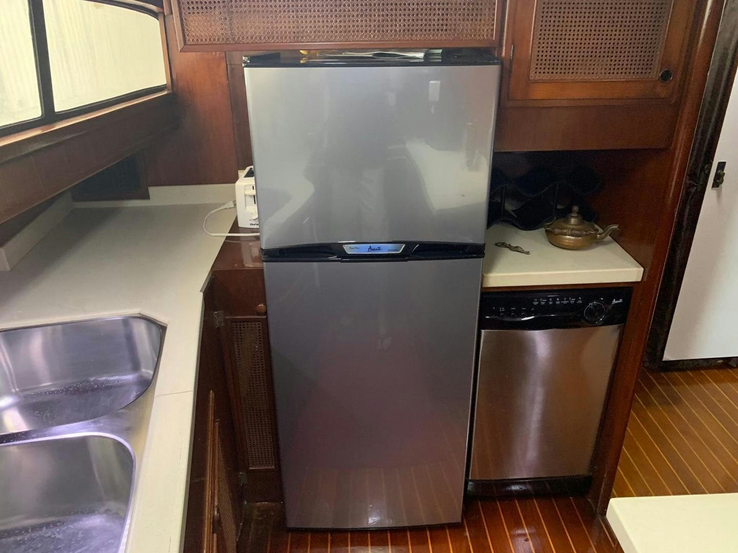 a kitchen with a stainless steel refrigerator aboard No Name Yacht for Sale