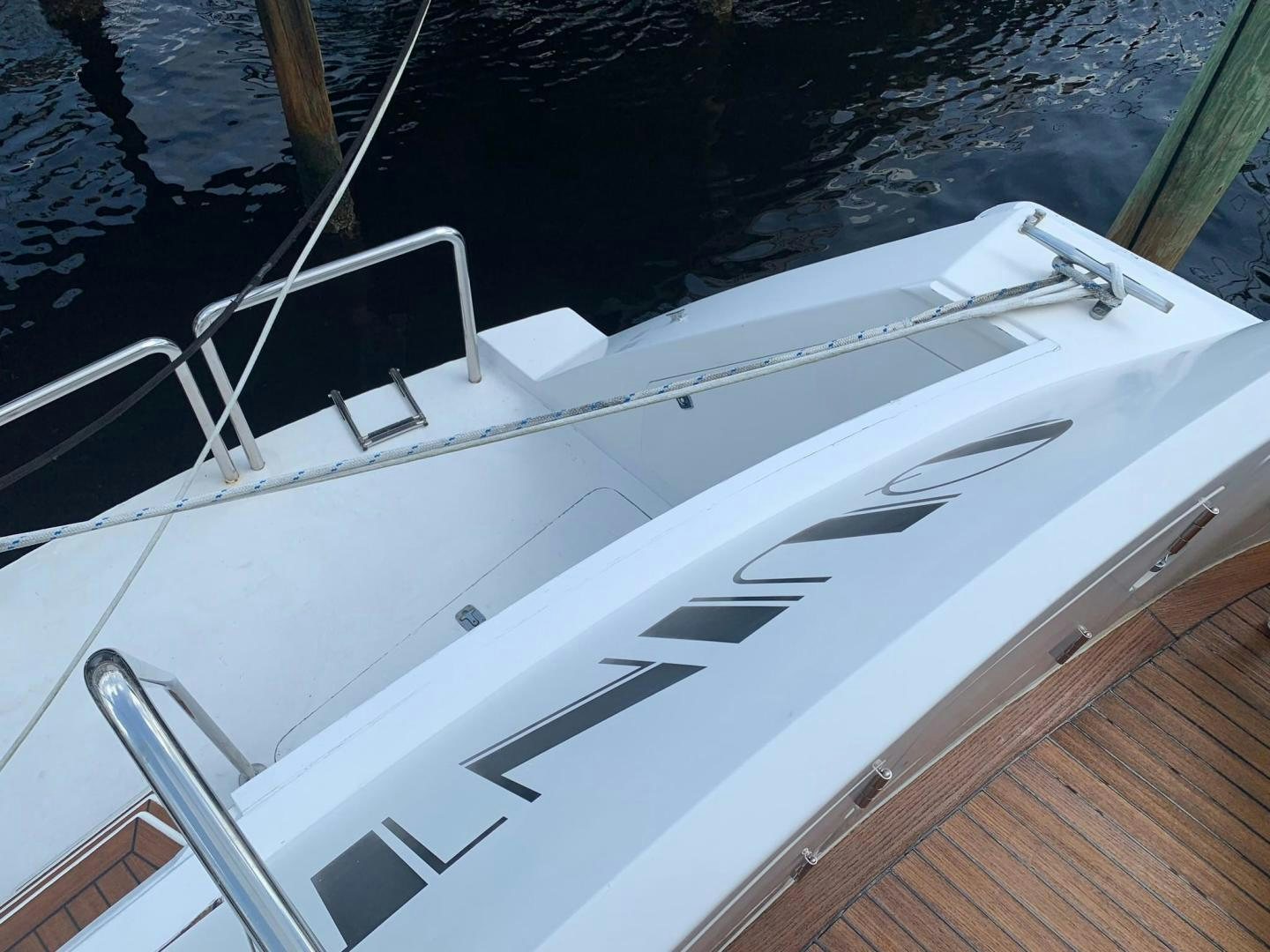 a white boat on a body of water aboard No Name Yacht for Sale