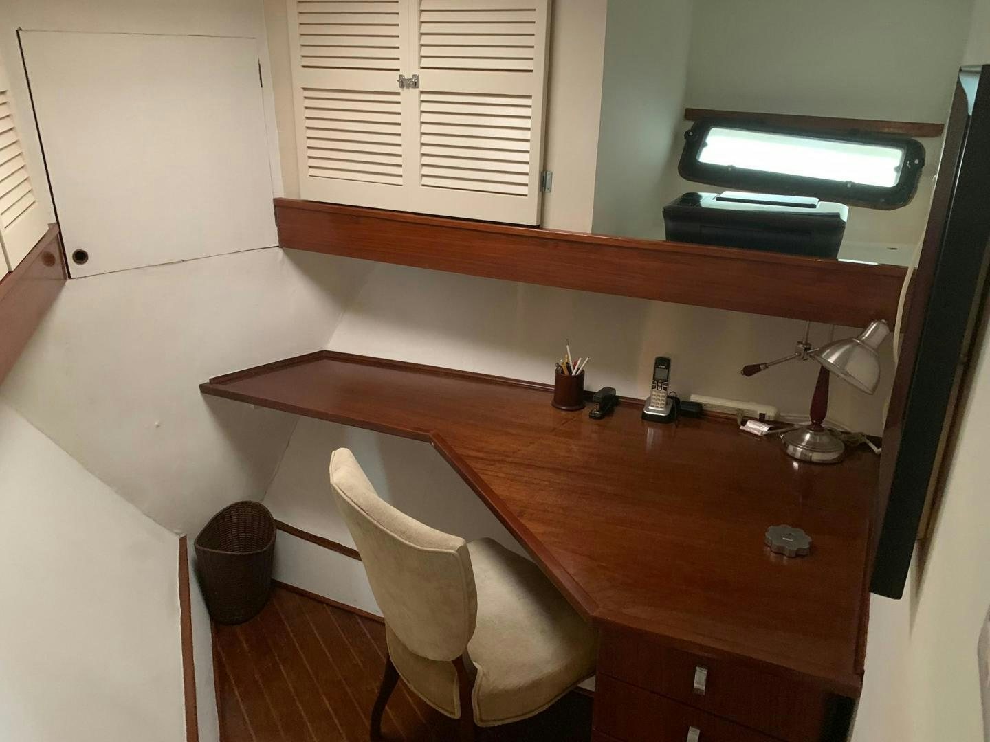 a table with a chair and a lamp on it aboard No Name Yacht for Sale