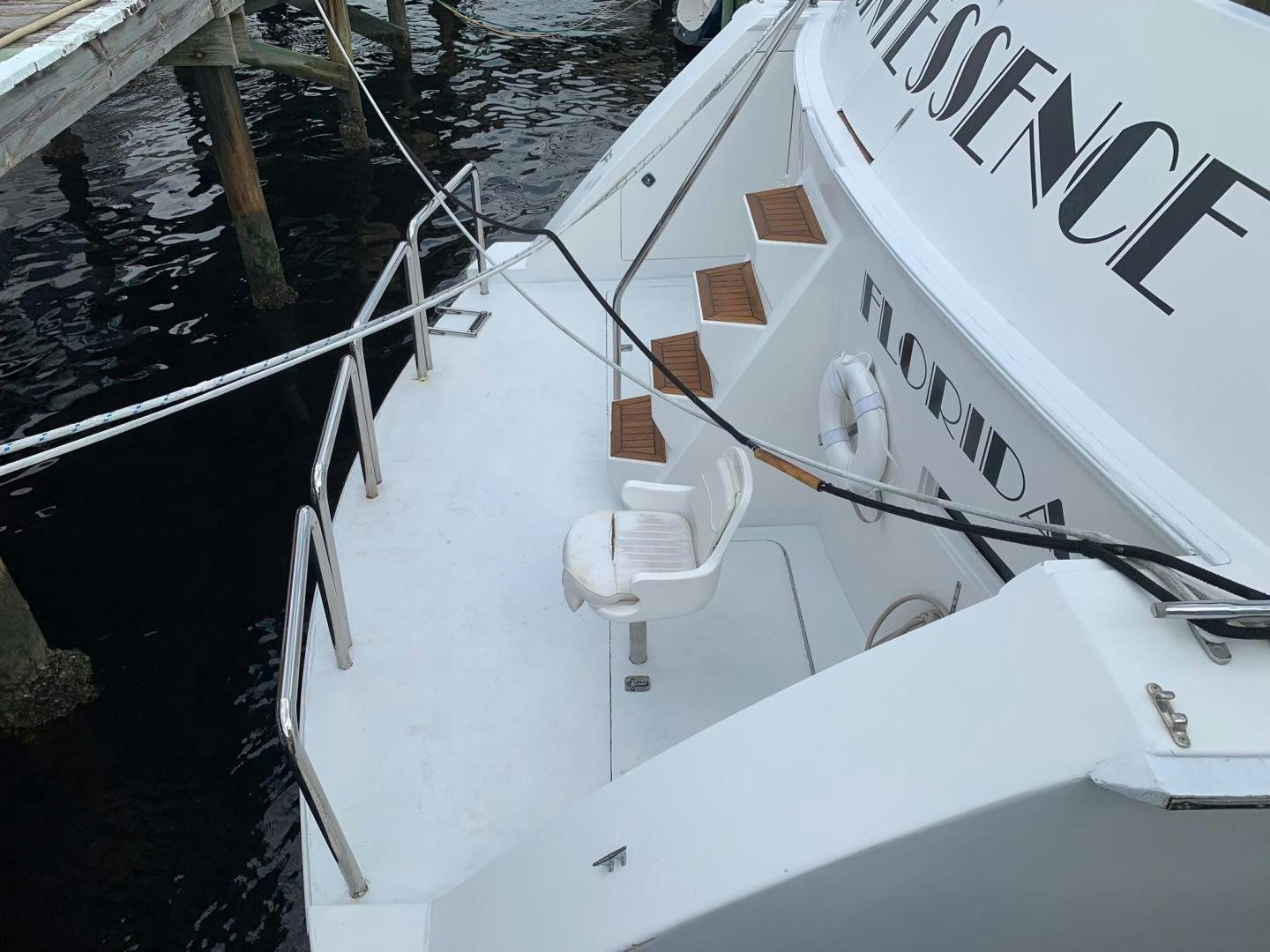 a white boat with a white sign aboard No Name Yacht for Sale