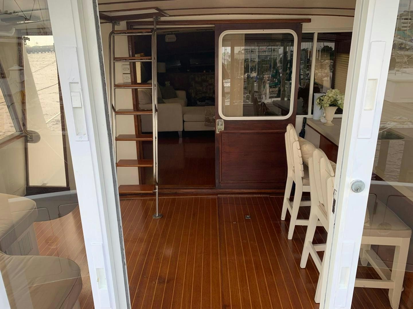 a room with a glass door and a wood floor aboard No Name Yacht for Sale