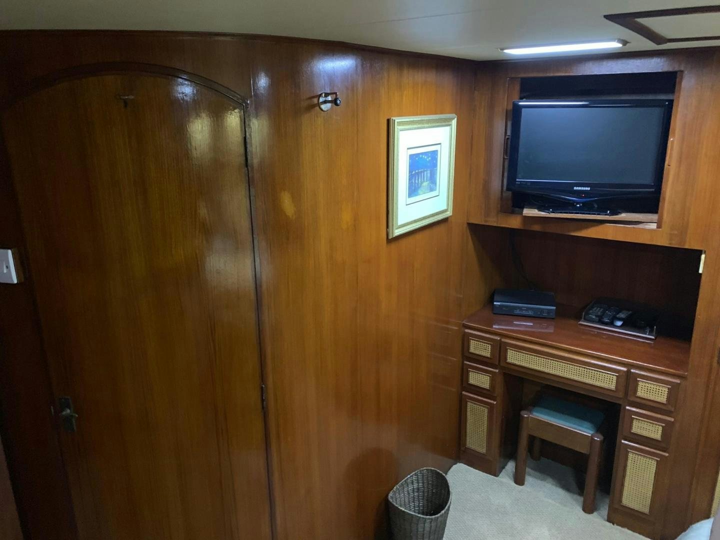 a wood cabinet with a television on it aboard No Name Yacht for Sale