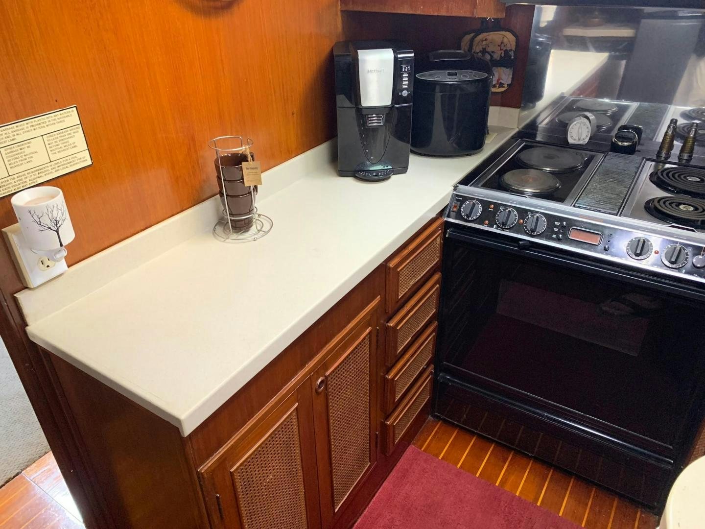 a kitchen with a stove and a coffee maker aboard No Name Yacht for Sale
