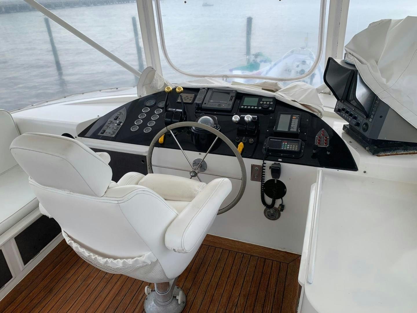 a black and white car with a steering wheel and a white chair aboard No Name Yacht for Sale