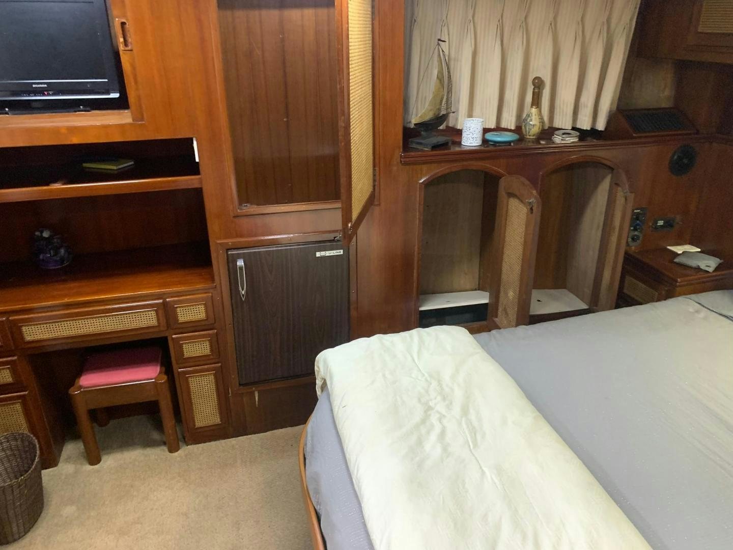 a room with a bed and desk aboard No Name Yacht for Sale