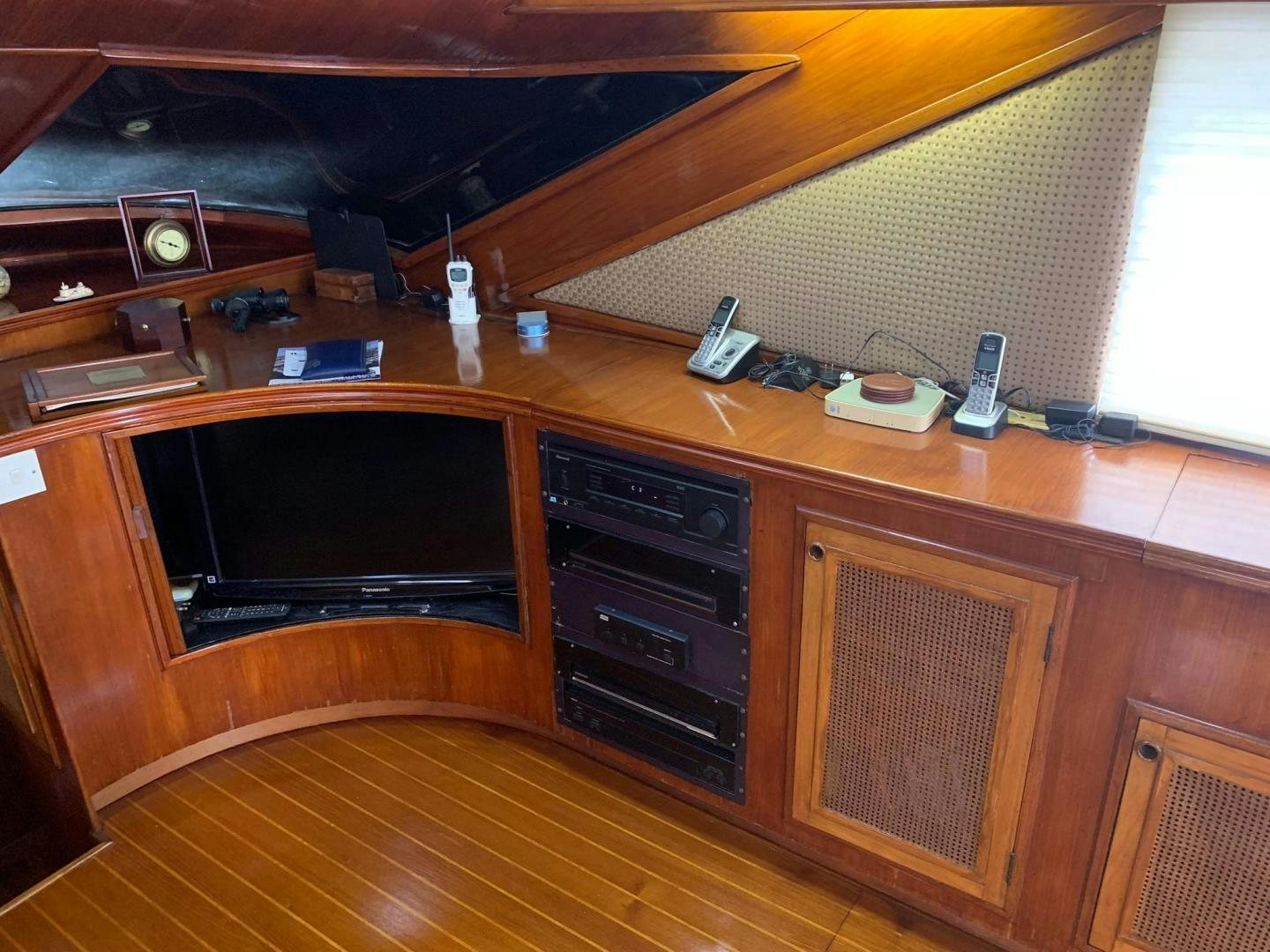 a wooden desk with a computer and other electronics on it aboard No Name Yacht for Sale