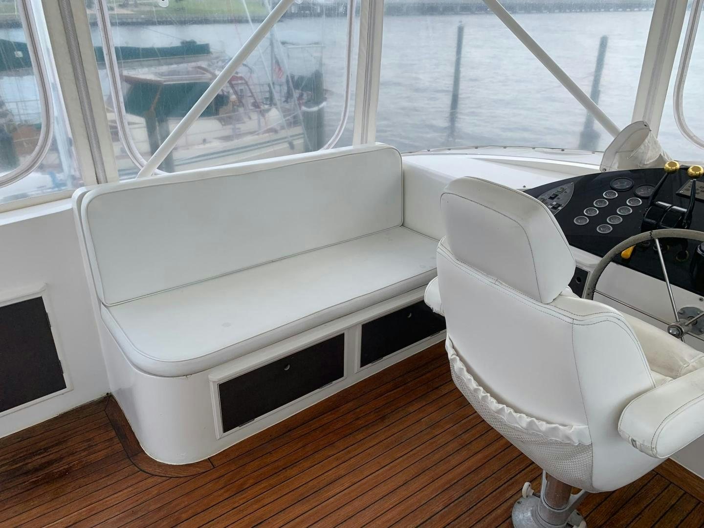 a white chair next to a window aboard No Name Yacht for Sale