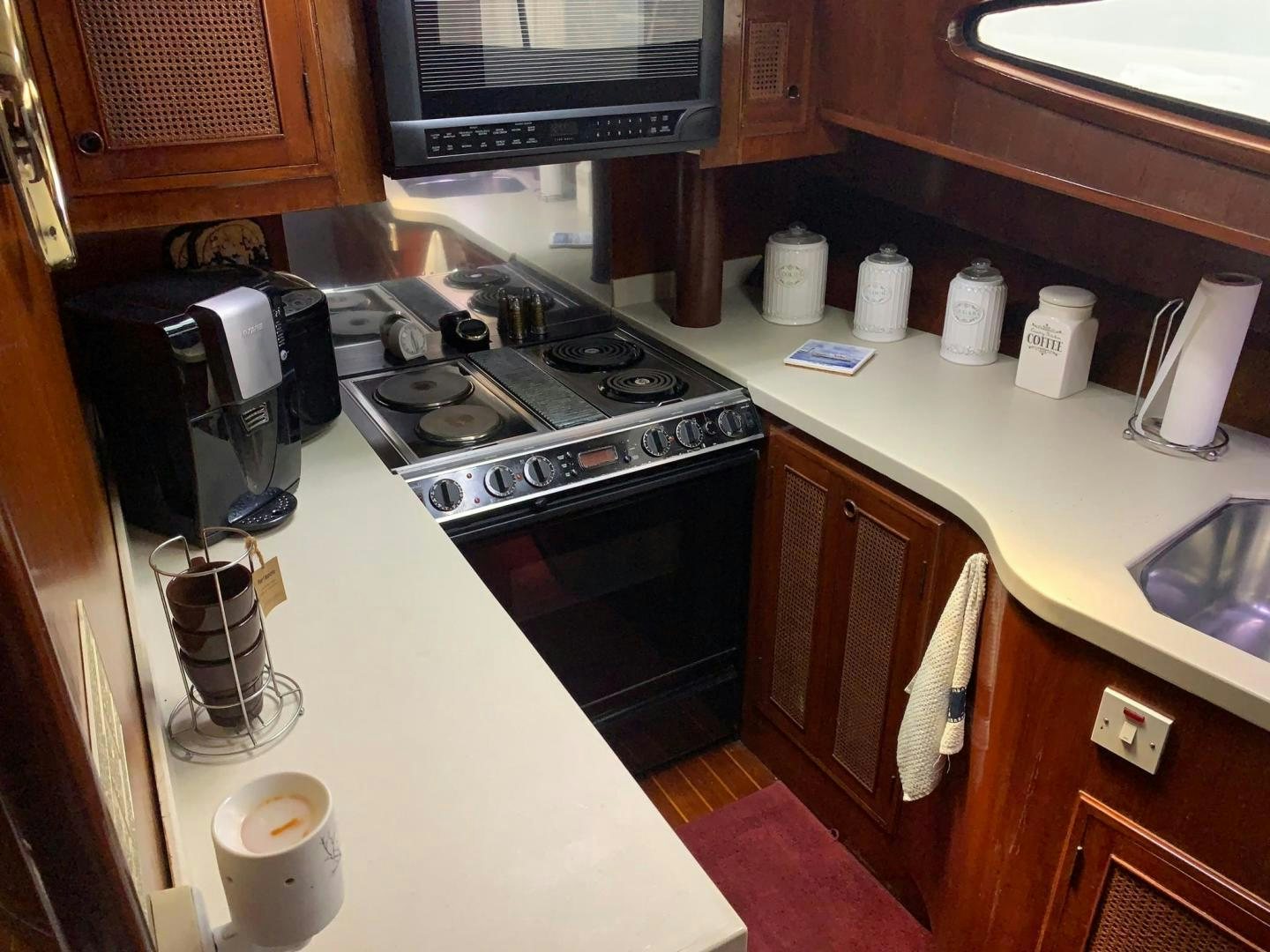 a kitchen with a stove and coffee maker aboard No Name Yacht for Sale