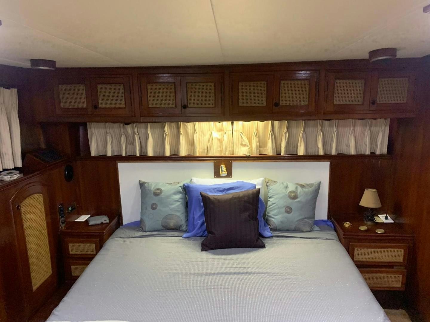 a bed with a white comforter and pillows aboard No Name Yacht for Sale