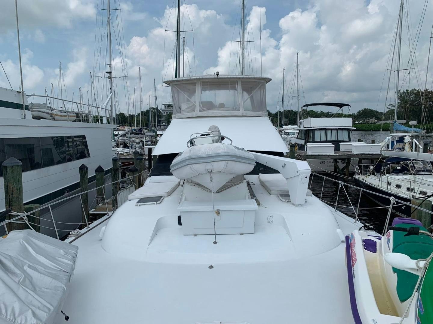 a white yacht in a harbor aboard No Name Yacht for Sale