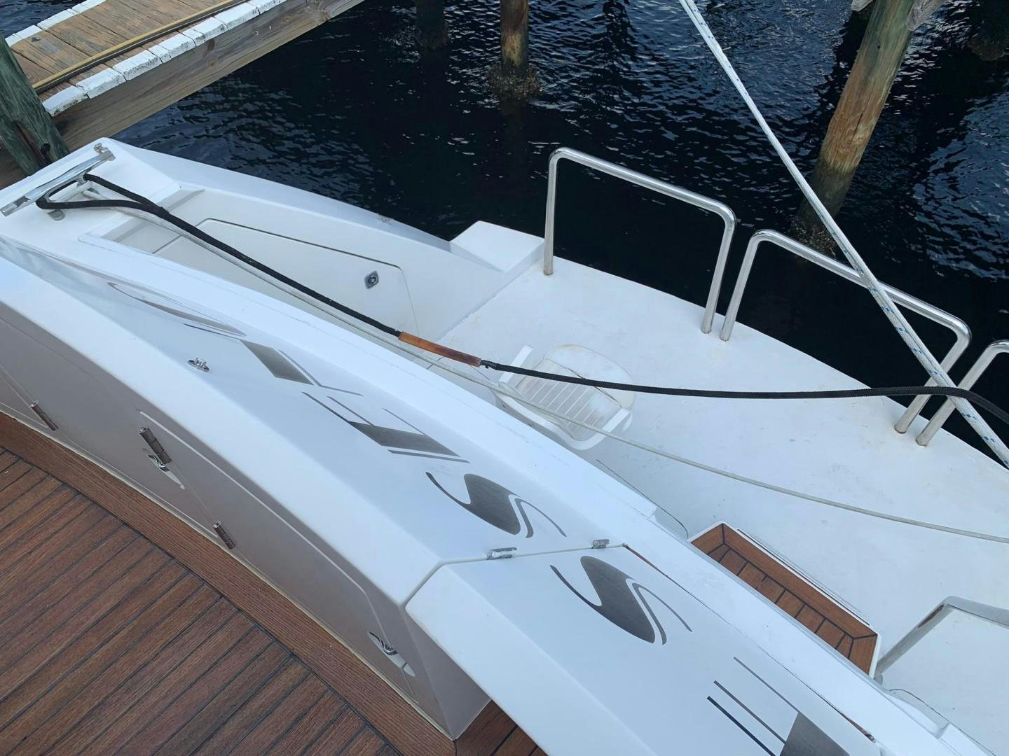 a white boat with a rope aboard No Name Yacht for Sale