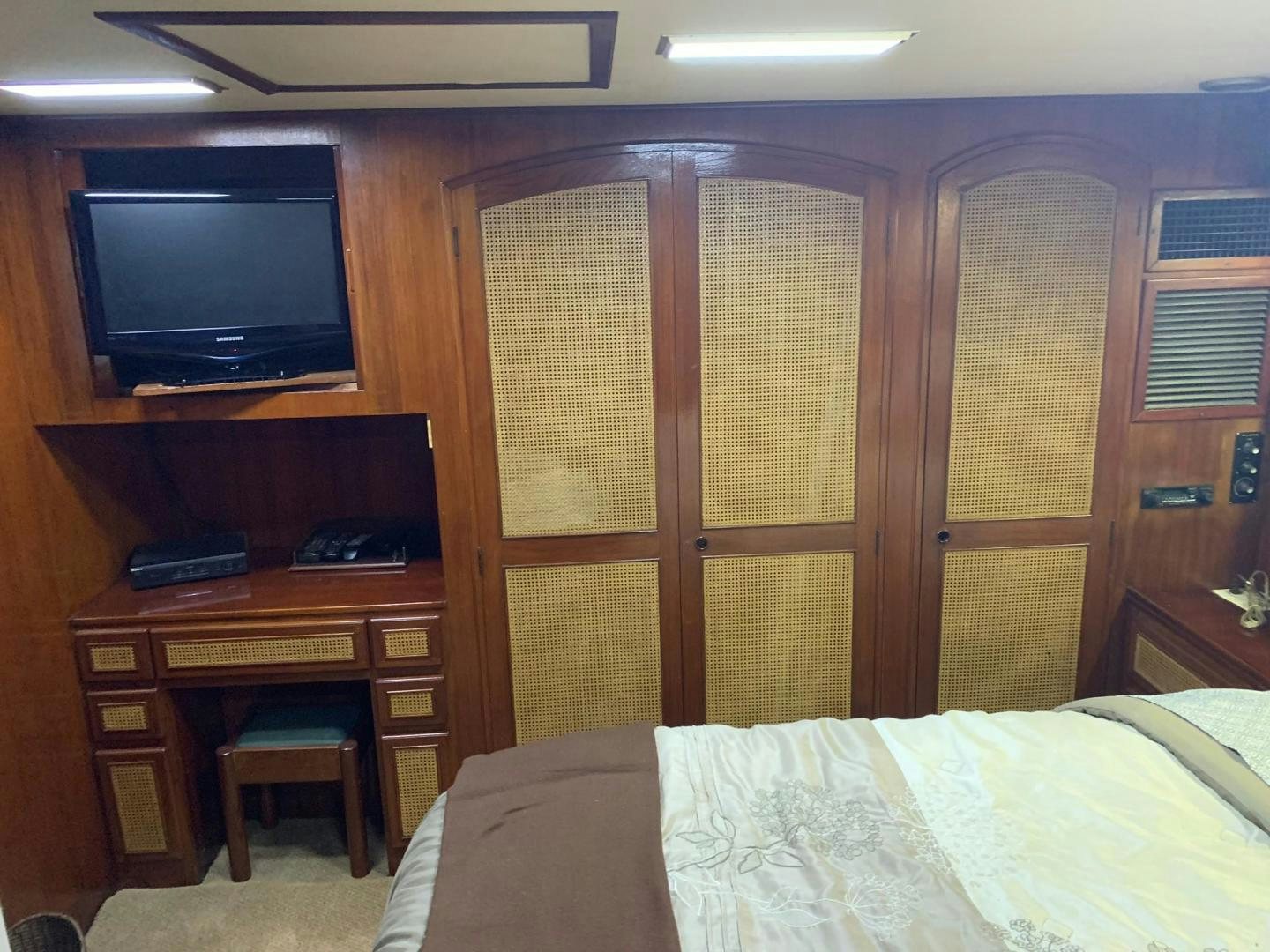 a bedroom with a desk and a tv aboard No Name Yacht for Sale