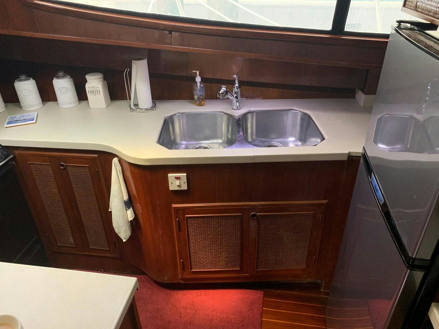 a kitchen with a sink and a refrigerator aboard No Name Yacht for Sale