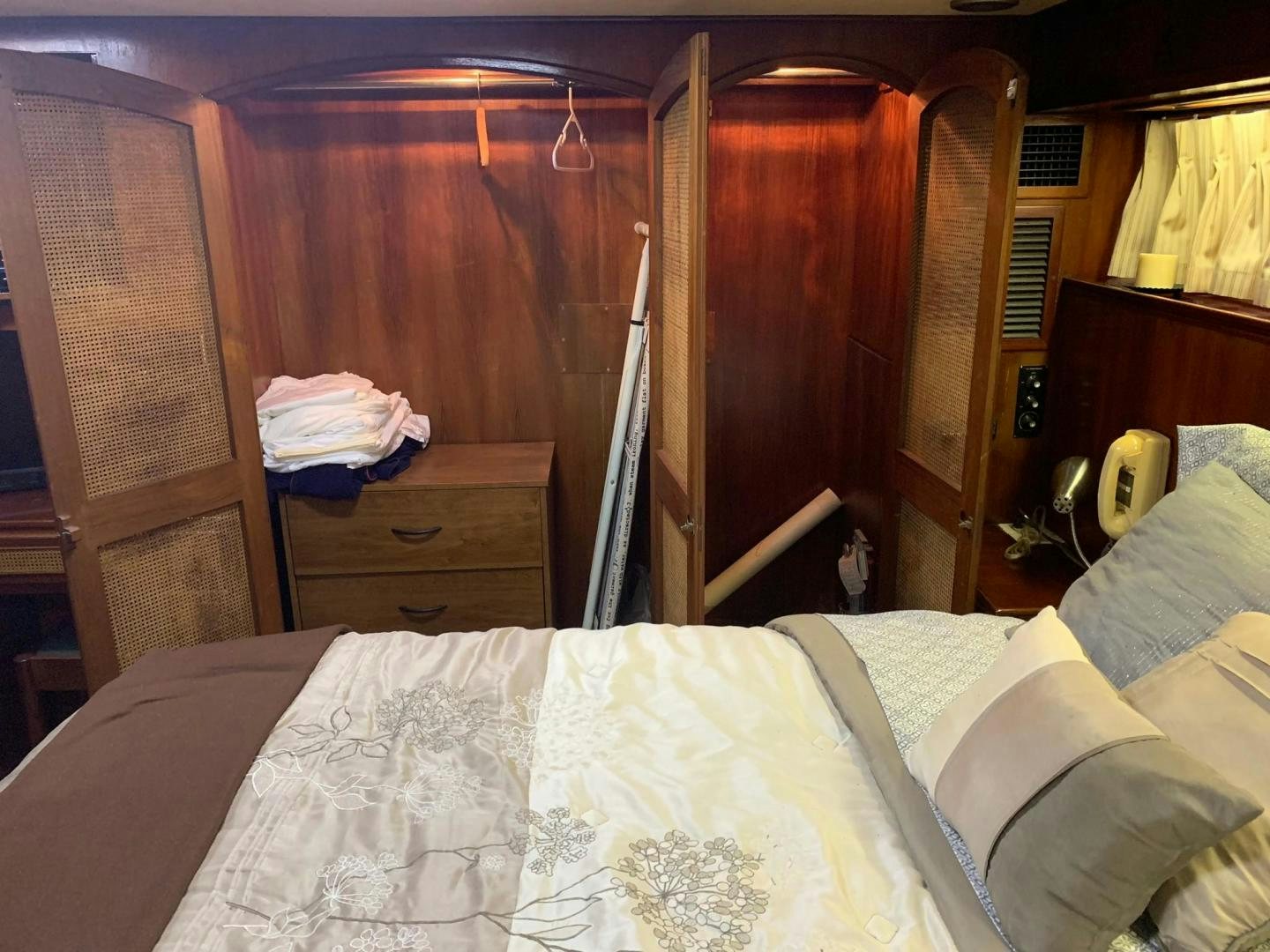a bedroom with a bed and a closet aboard No Name Yacht for Sale