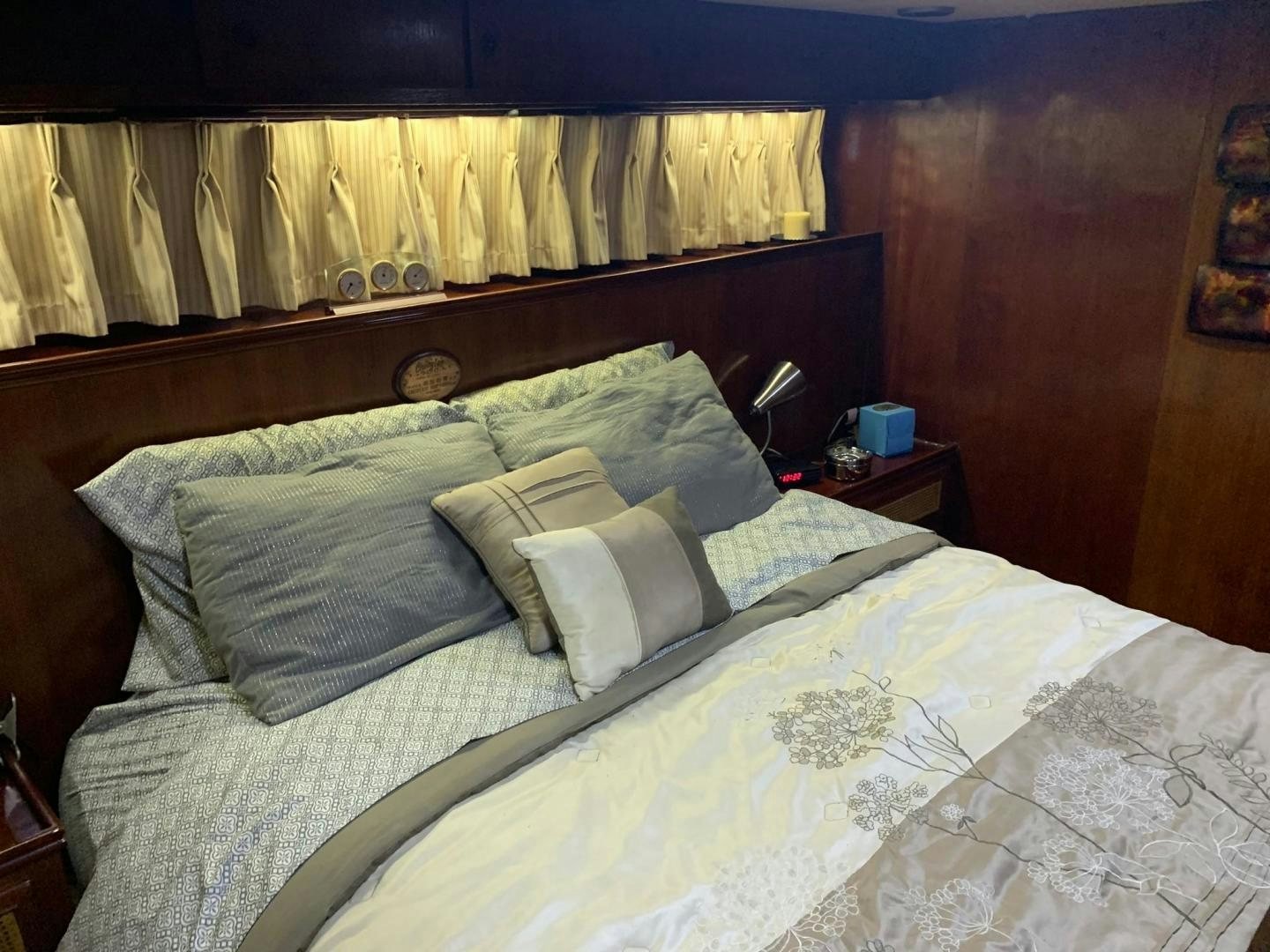 a bed with a white comforter and pillows aboard No Name Yacht for Sale