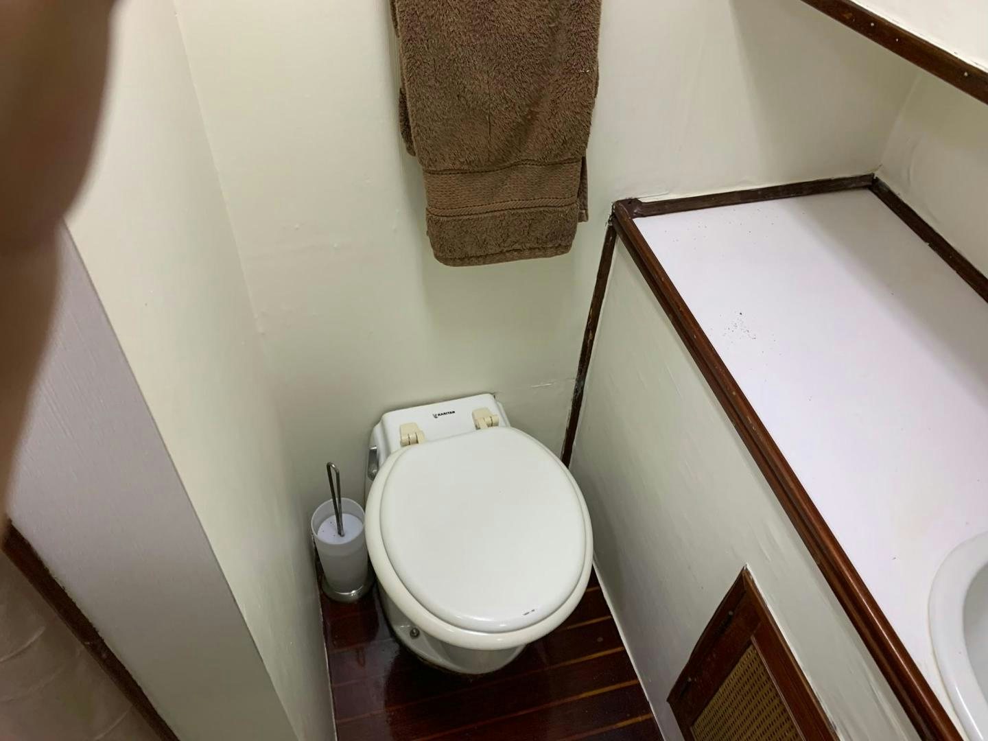 a toilet with a towel over it aboard No Name Yacht for Sale