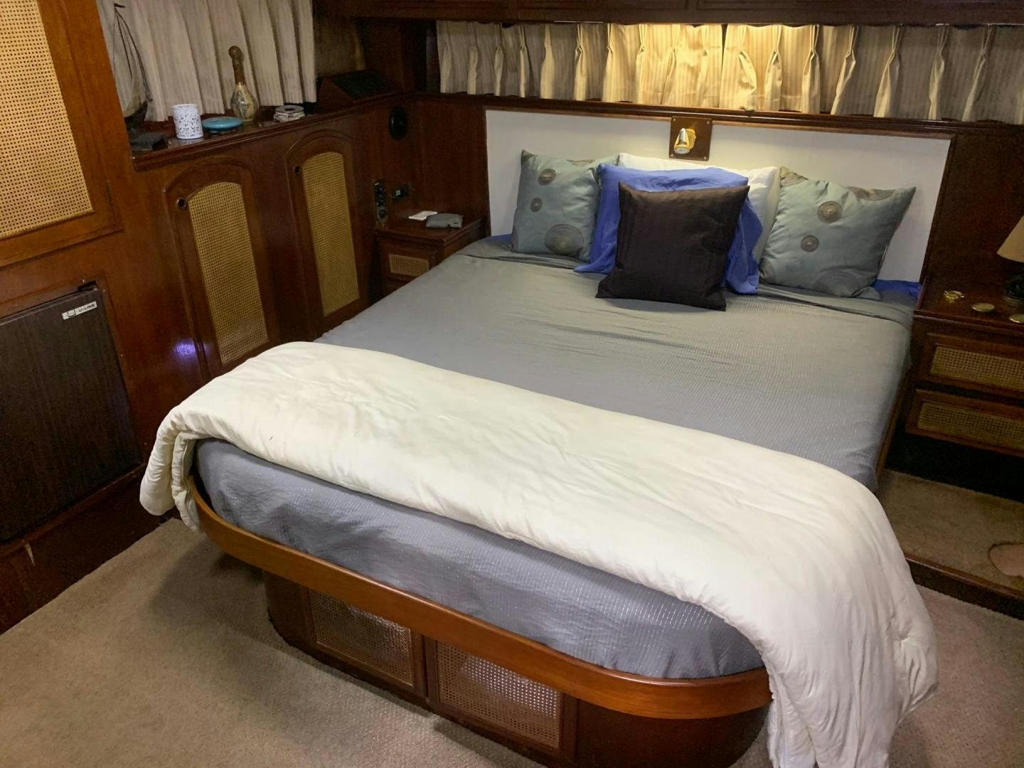 a bed with blue and white pillows aboard No Name Yacht for Sale
