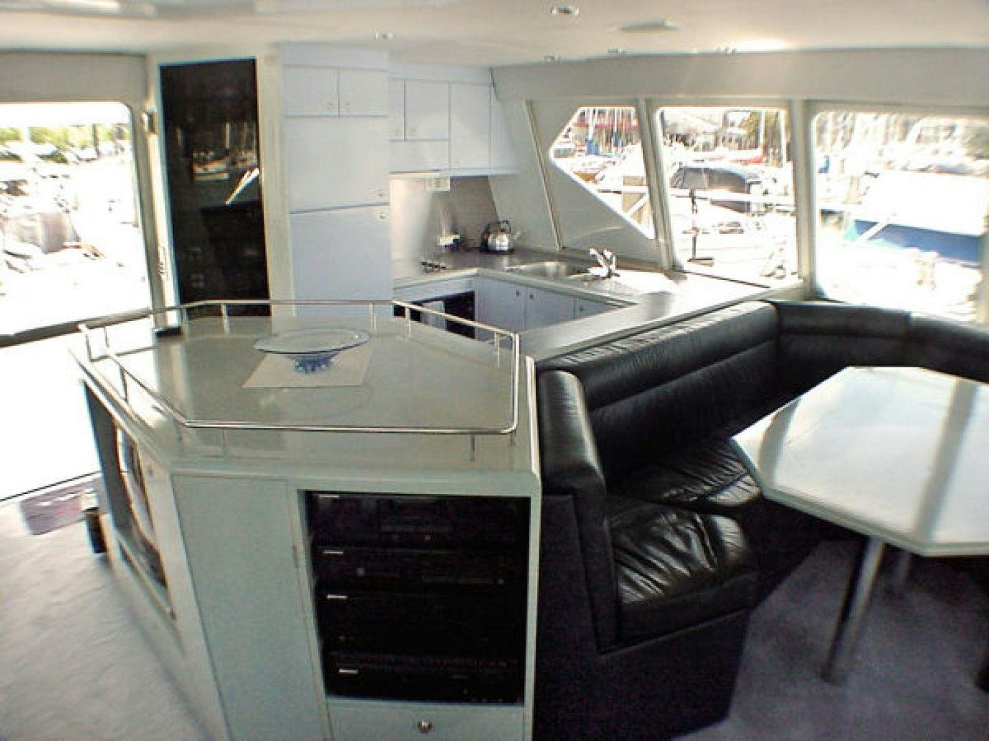 a kitchen with a counter and chairs aboard O'NEILL Yacht for Sale