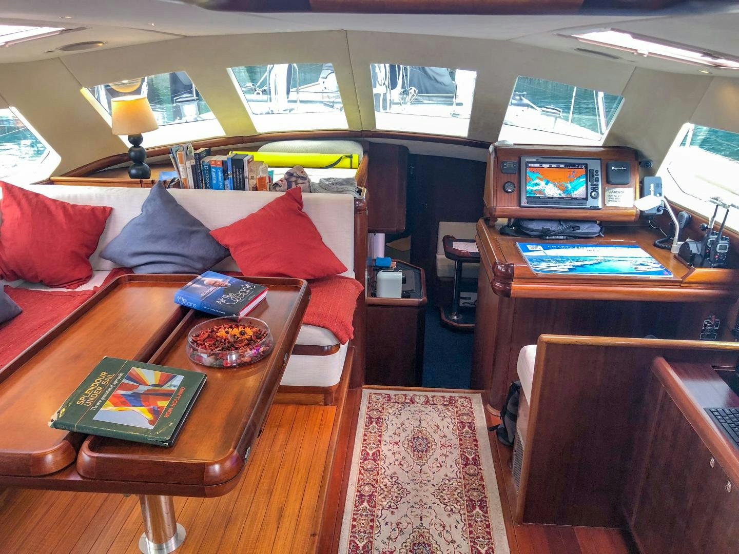 a living room with a red couch and a television aboard GOLDEN OPUS Yacht for Sale