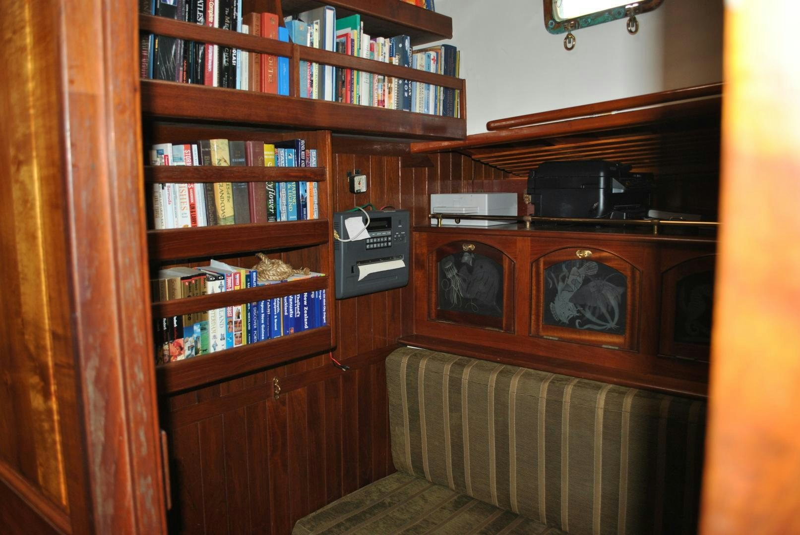 a shelf with a stereo and a bookcase aboard TREE OF LIFE Yacht for Sale
