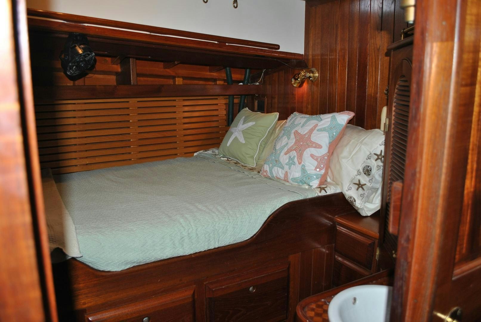 a bed with white sheets and pillows aboard TREE OF LIFE Yacht for Sale