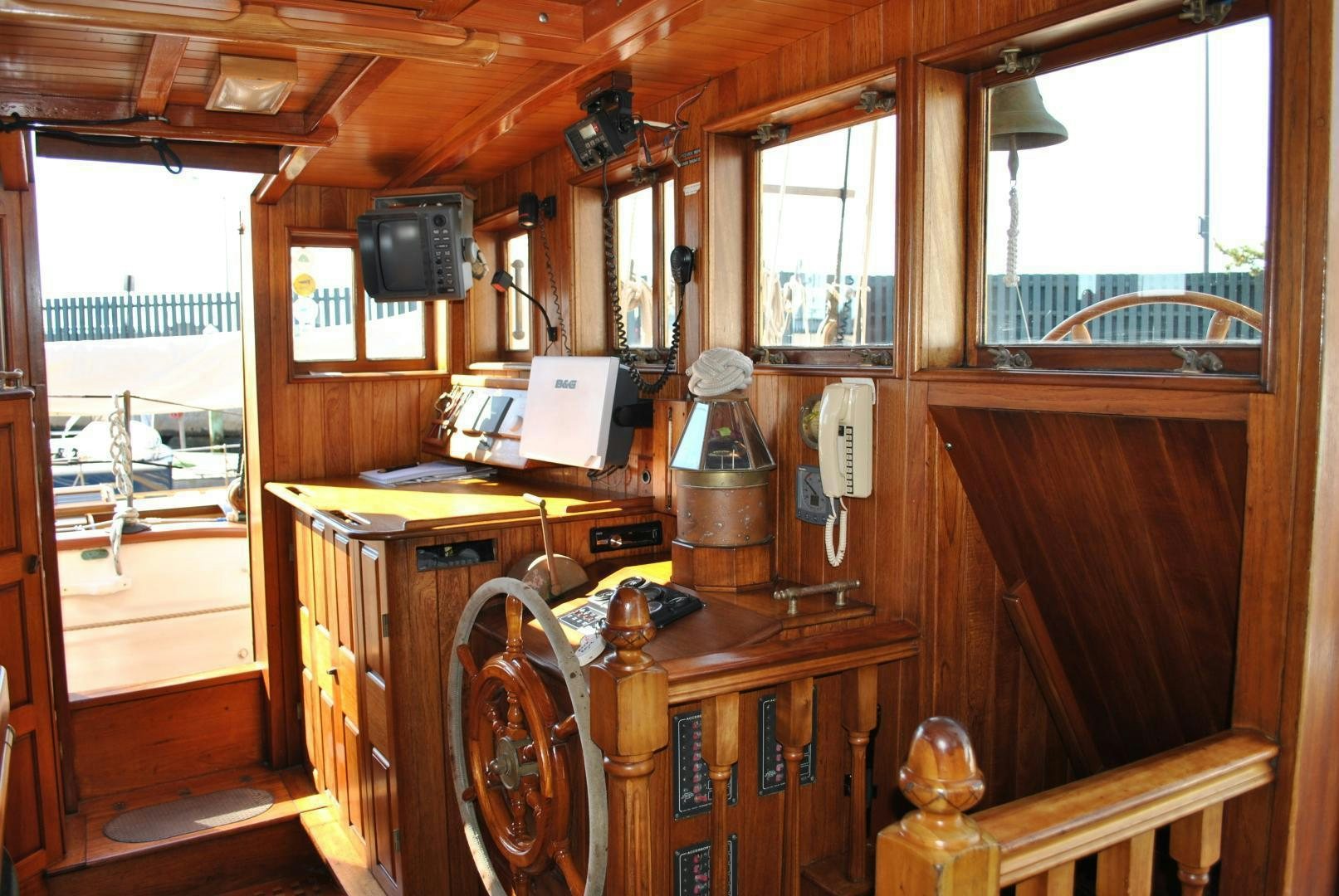 a wooden cabin with a wood paneled room with a wood door and a window with a wood aboard TREE OF LIFE Yacht for Sale