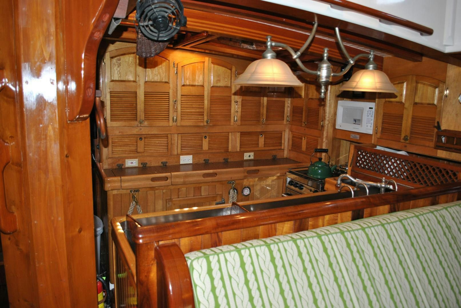 a kitchen with wooden cabinets aboard TREE OF LIFE Yacht for Sale