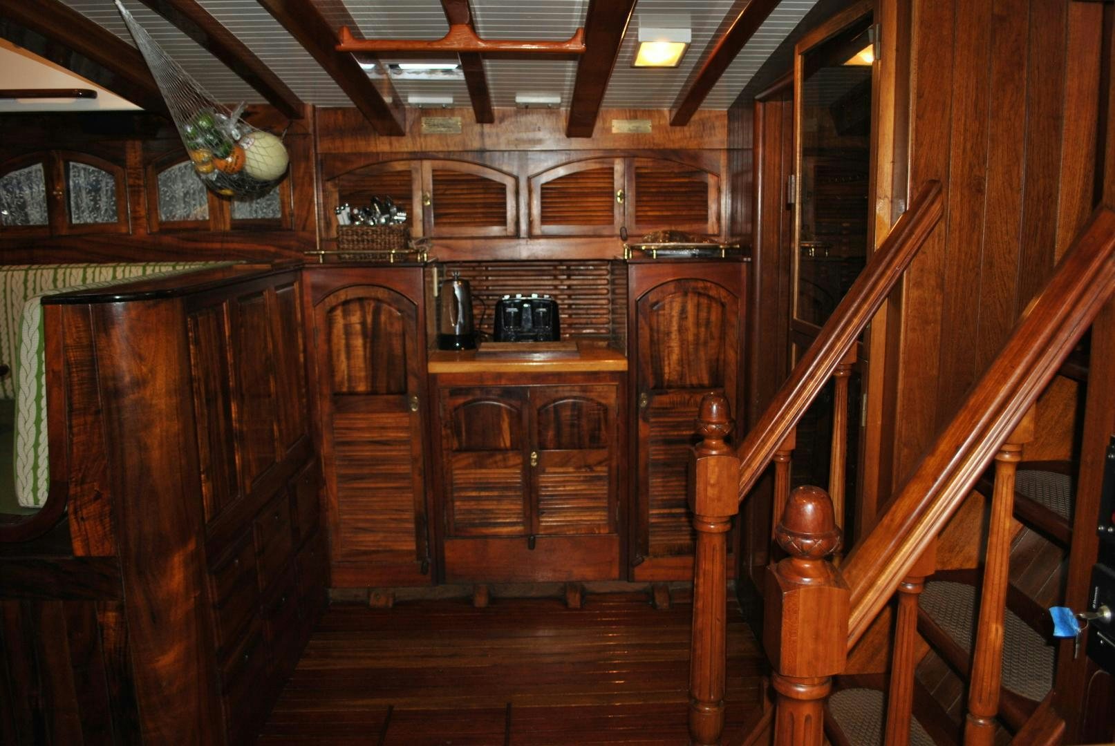 a kitchen with wooden cabinets aboard TREE OF LIFE Yacht for Sale