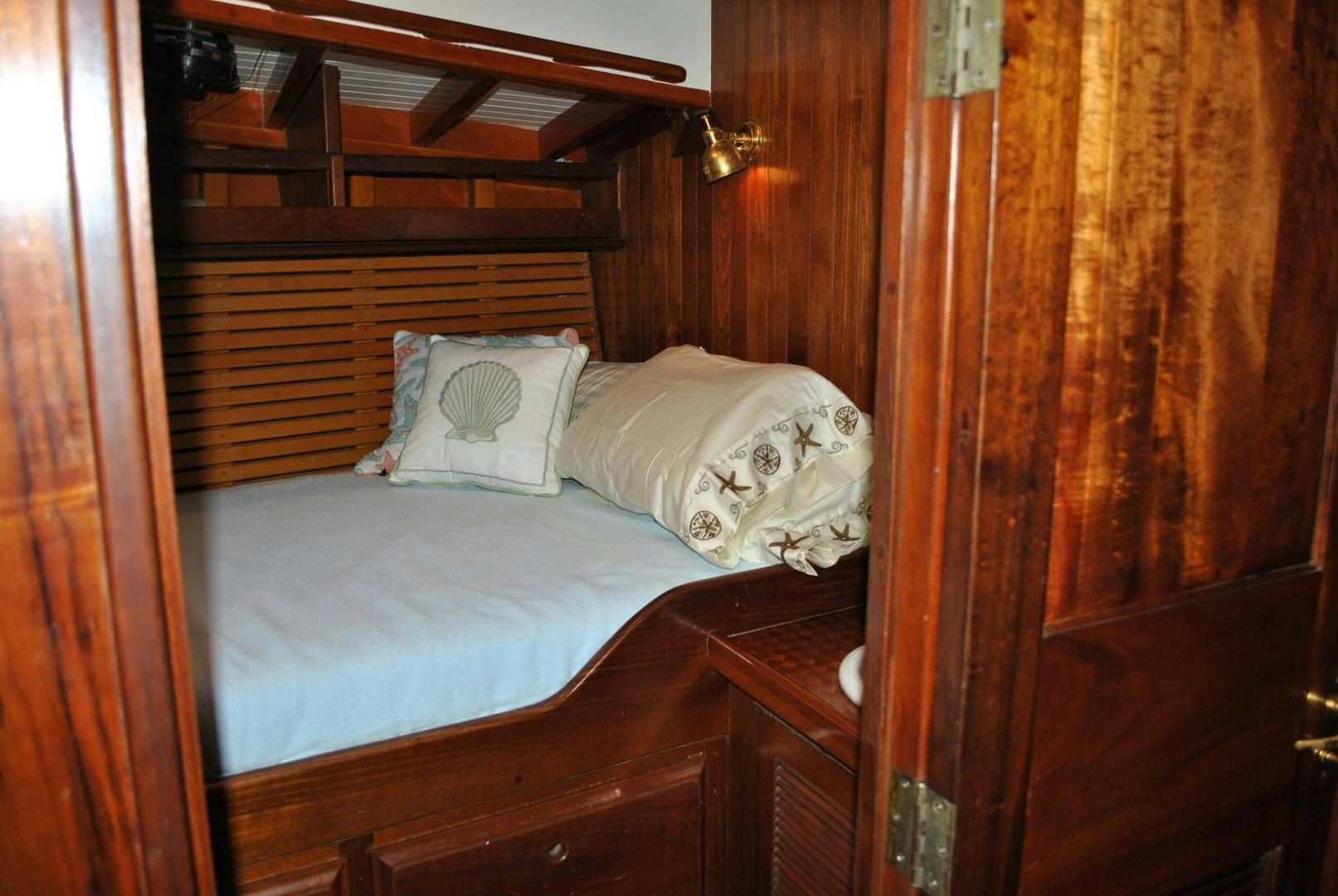 a bed with white sheets aboard TREE OF LIFE Yacht for Sale