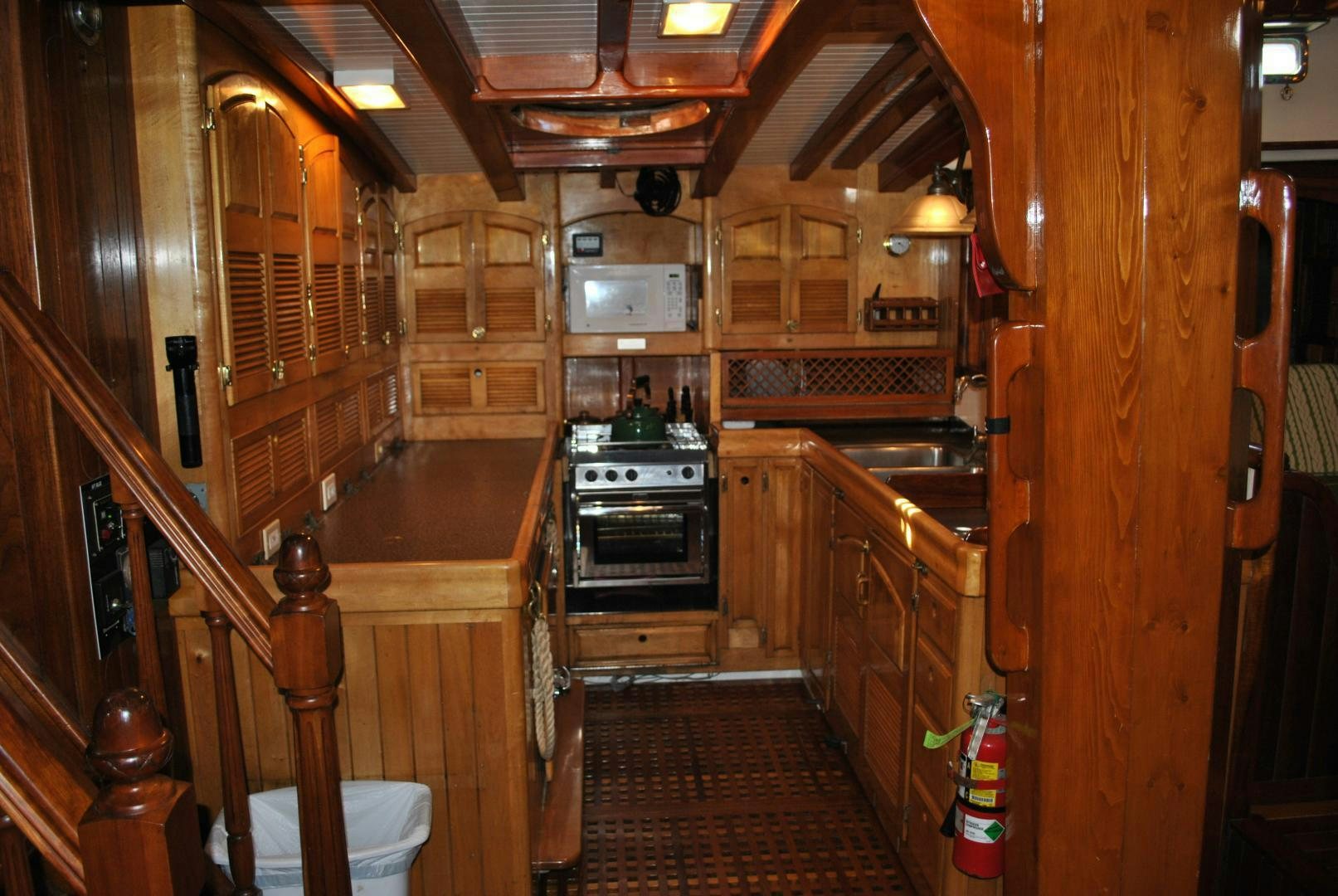 a kitchen with wooden cabinets aboard TREE OF LIFE Yacht for Sale