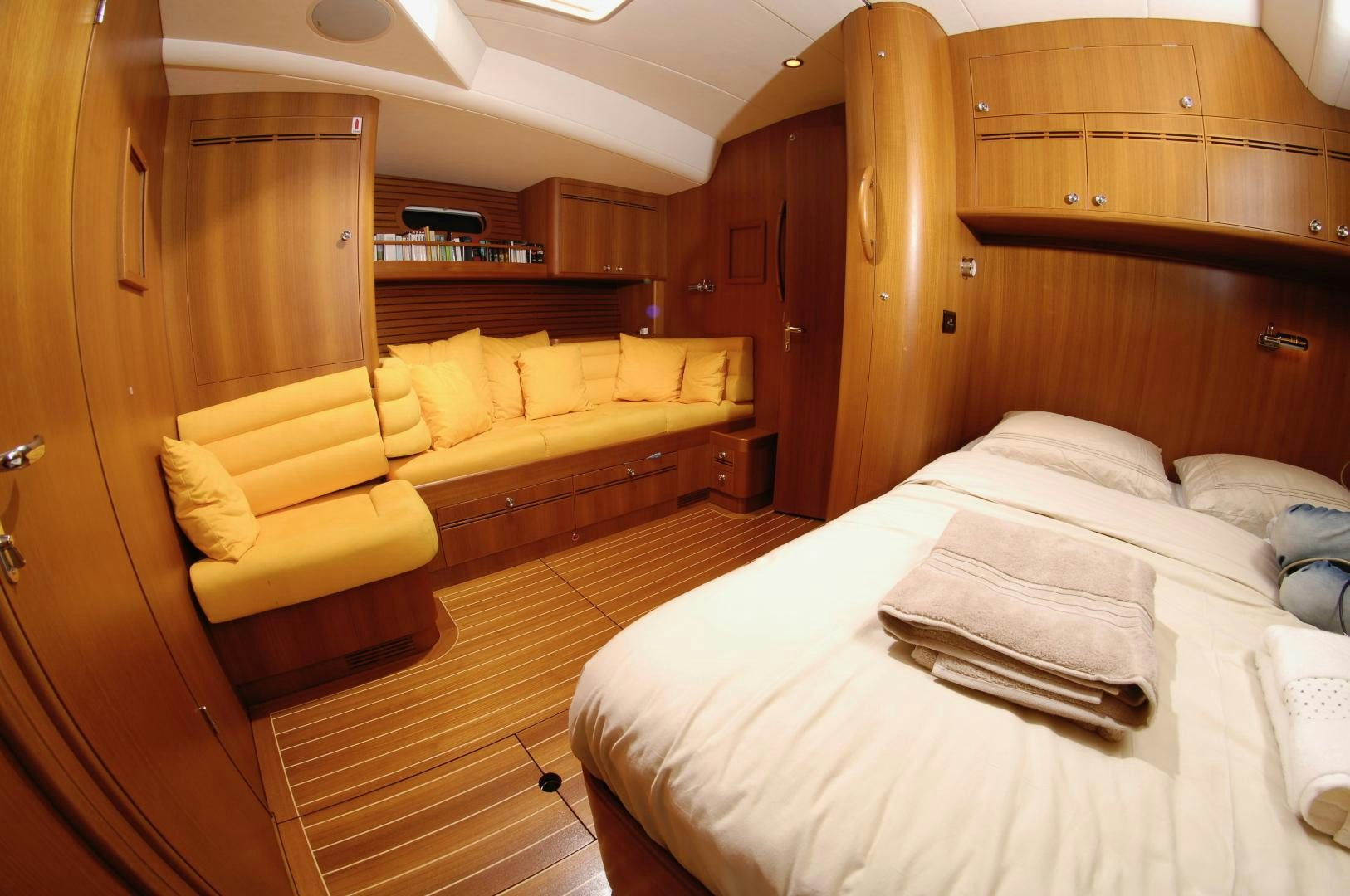 a room with a bed and a couch aboard PULSAR II Yacht for Sale