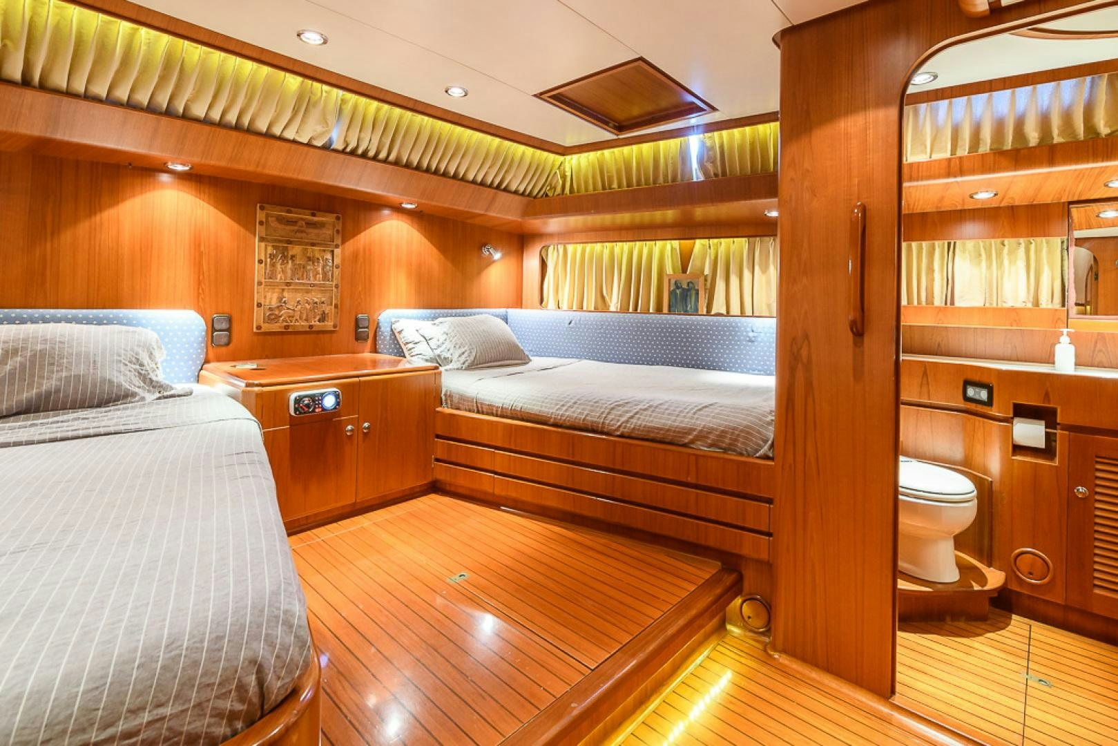 a bedroom with wood floors aboard CRYSTAL Yacht for Sale