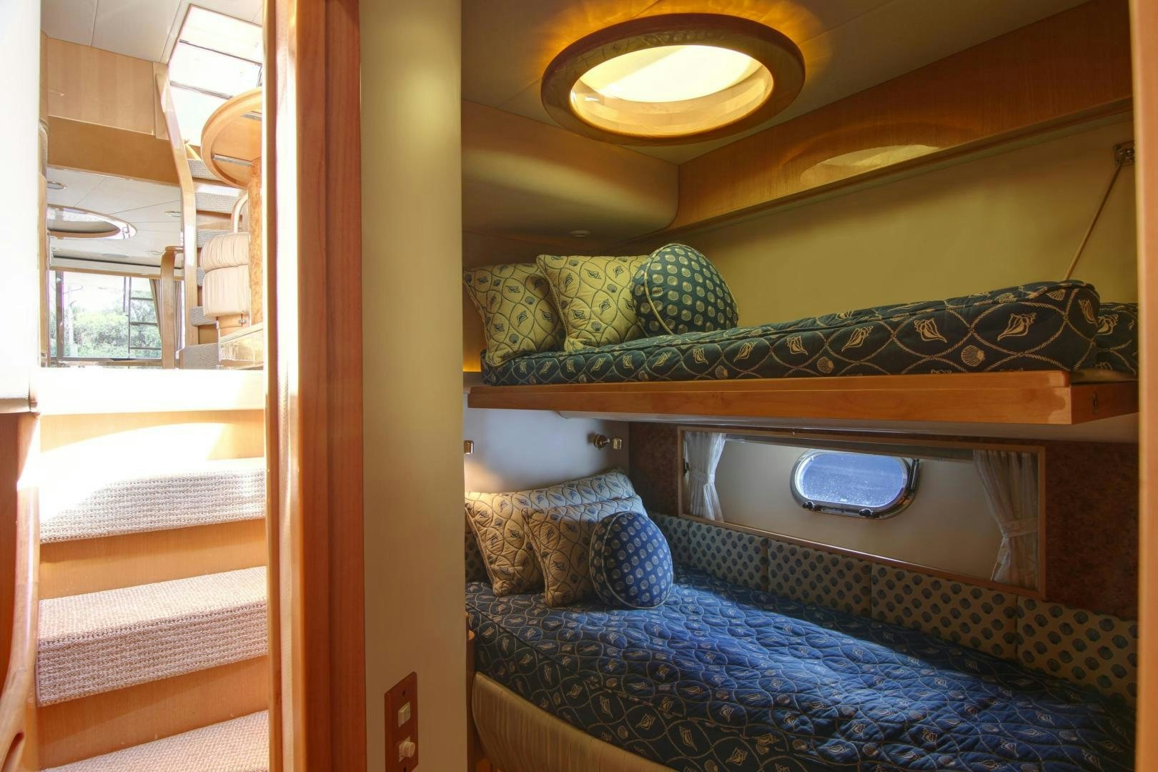 a bed with a blue blanket aboard UNSINKABLE II Yacht for Sale