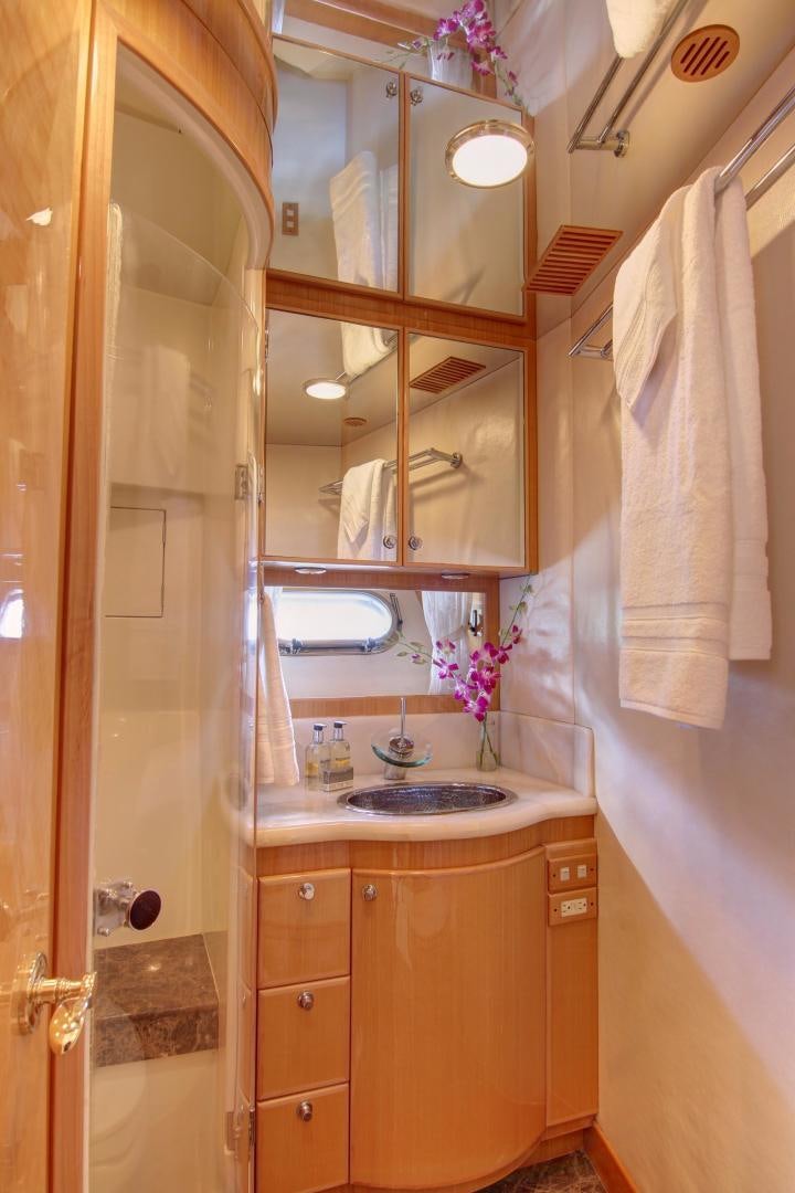 a bathroom with a sink and a mirror aboard UNSINKABLE II Yacht for Sale