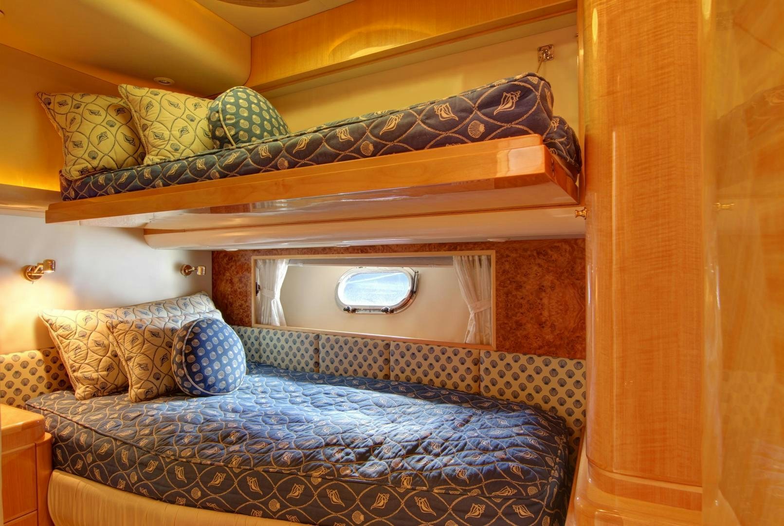 a bed with a blue blanket aboard UNSINKABLE II Yacht for Sale