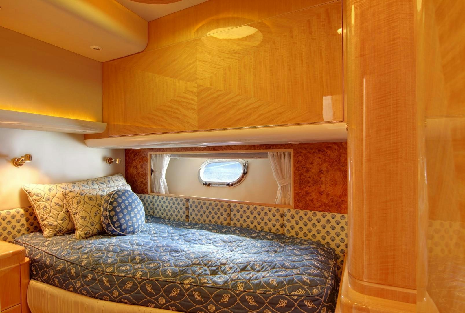 a bed with a blue blanket aboard UNSINKABLE II Yacht for Sale