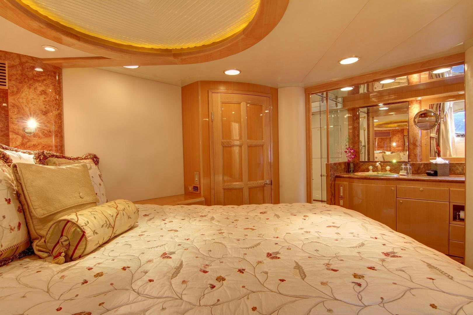 a bed with a white comforter aboard UNSINKABLE II Yacht for Sale