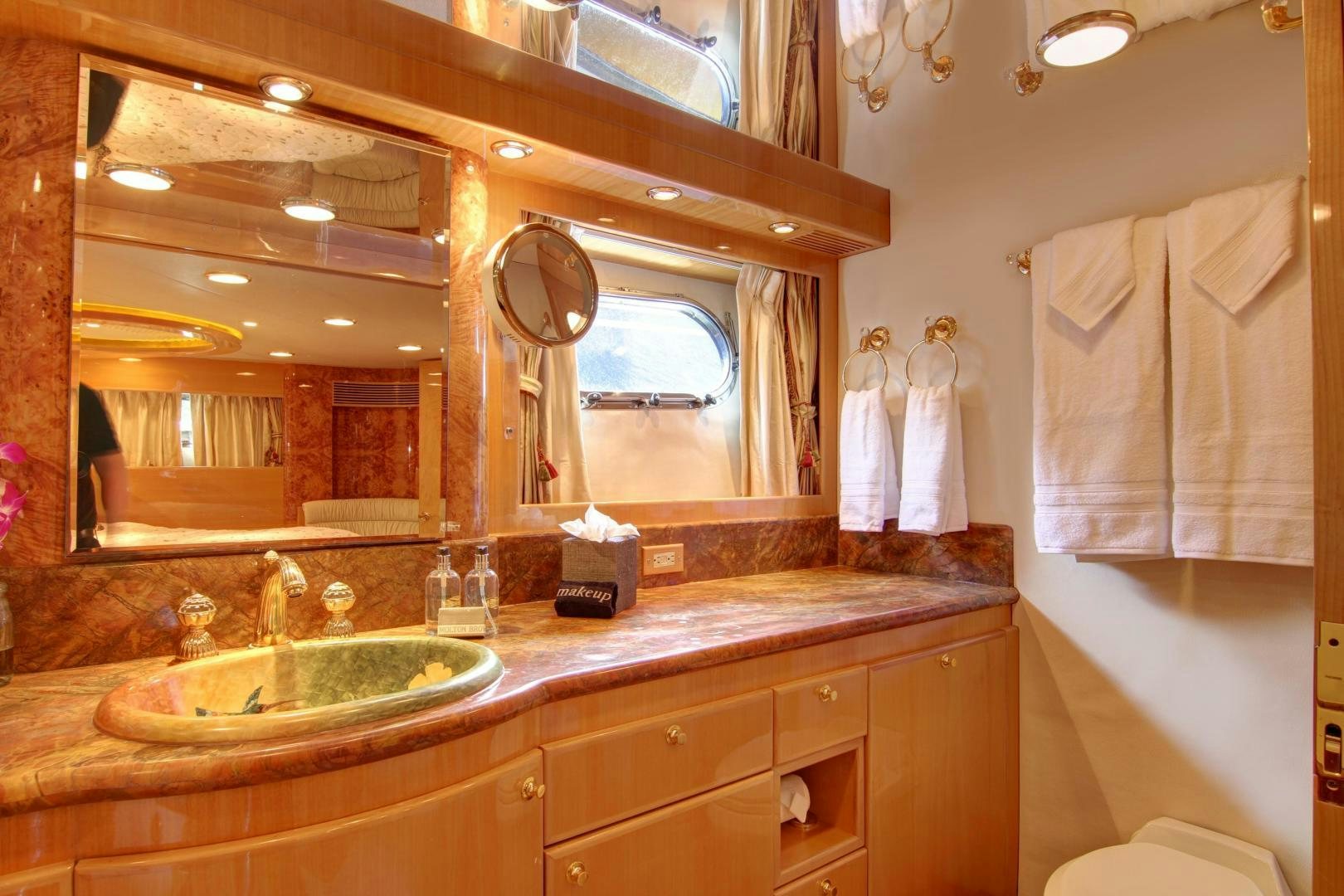 a bathroom with a large mirror aboard UNSINKABLE II Yacht for Sale