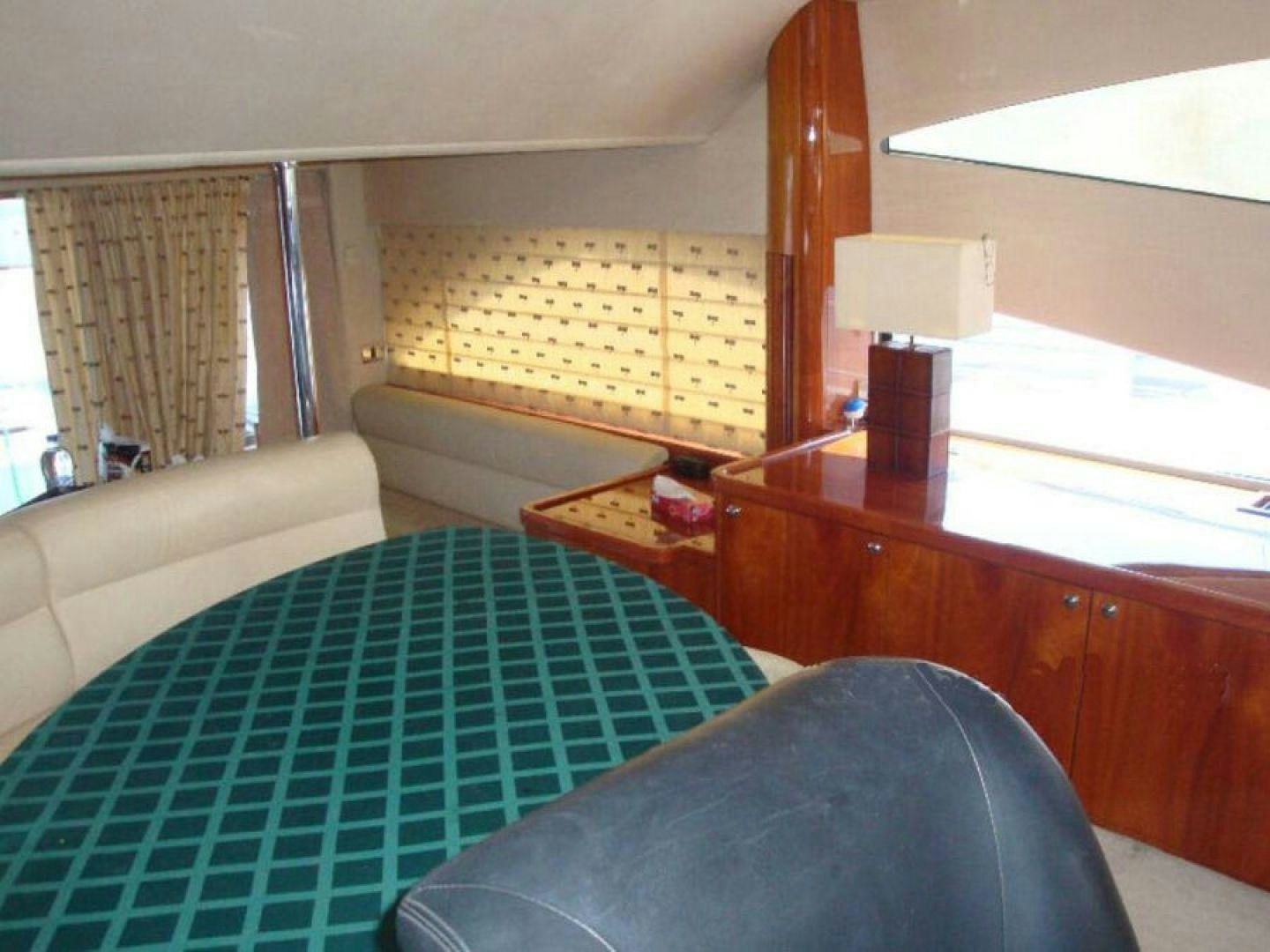 a bedroom with a bed and a desk aboard PURA VIDA Yacht for Sale