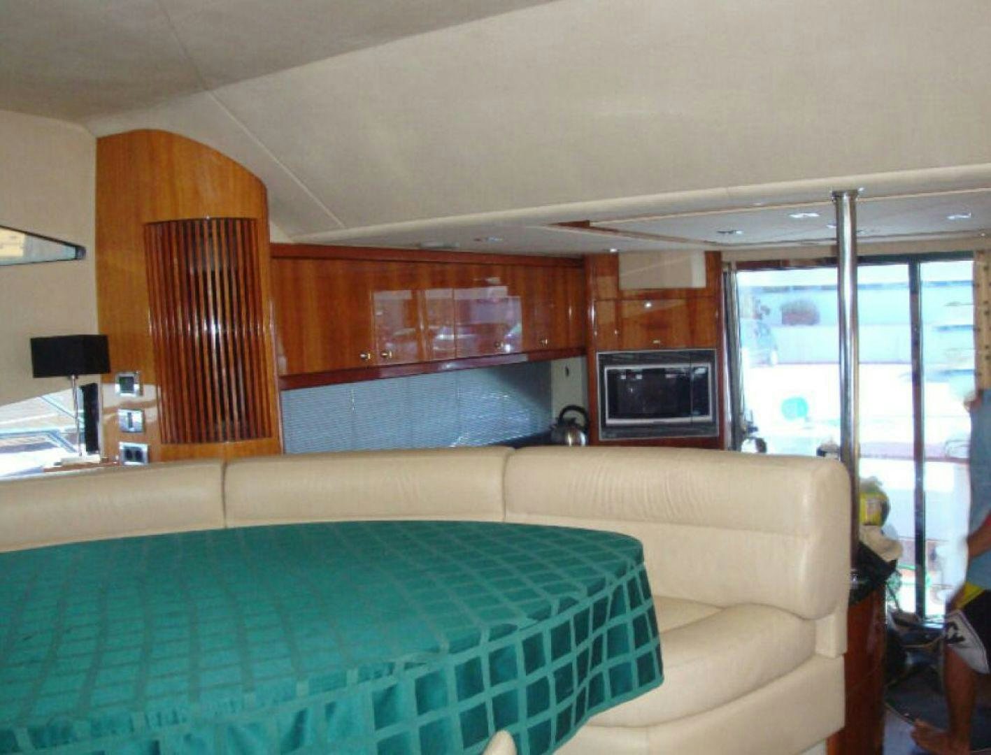 a living room with a couch and a television aboard PURA VIDA Yacht for Sale