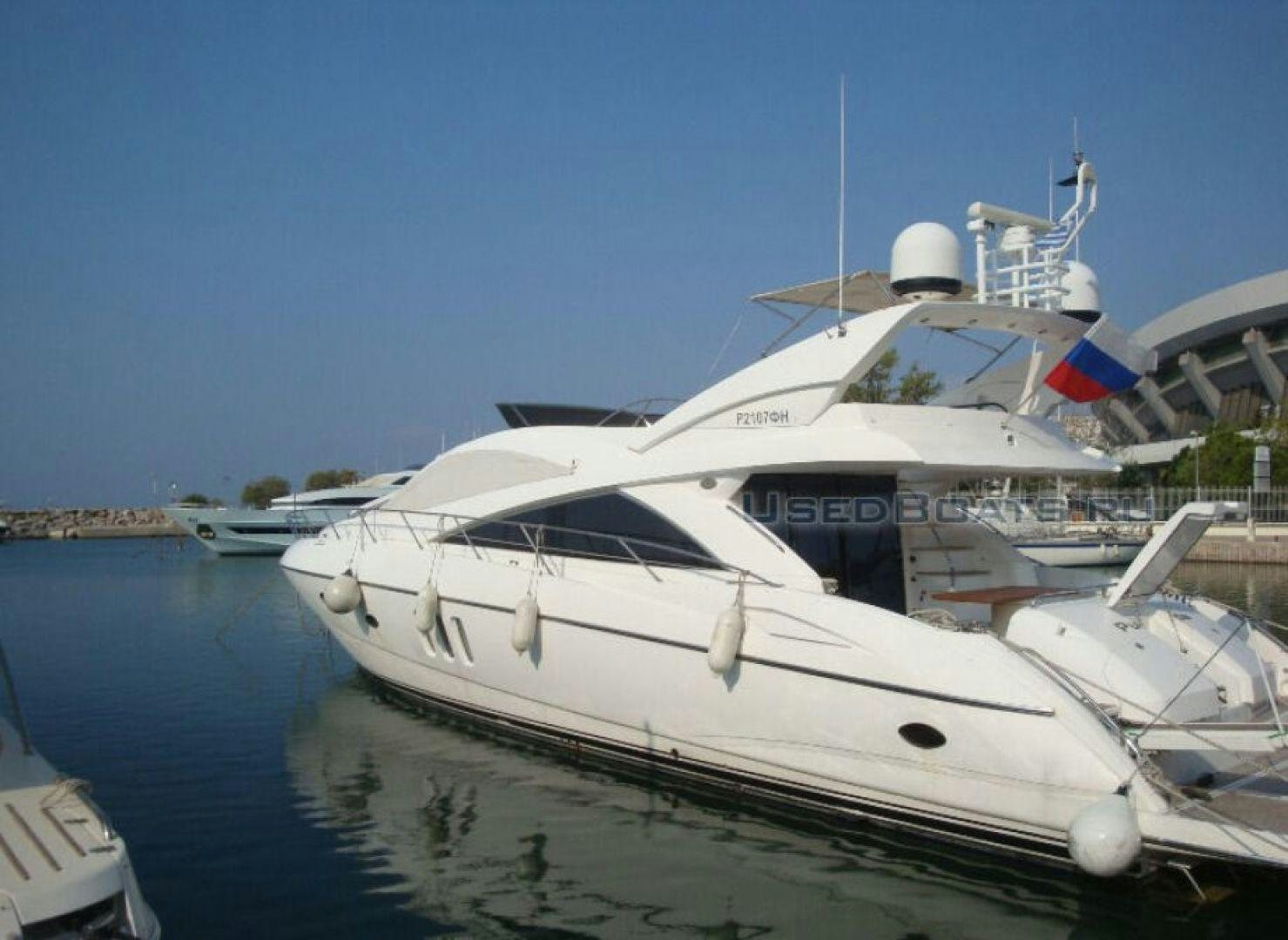 a white yacht docked aboard PURA VIDA Yacht for Sale