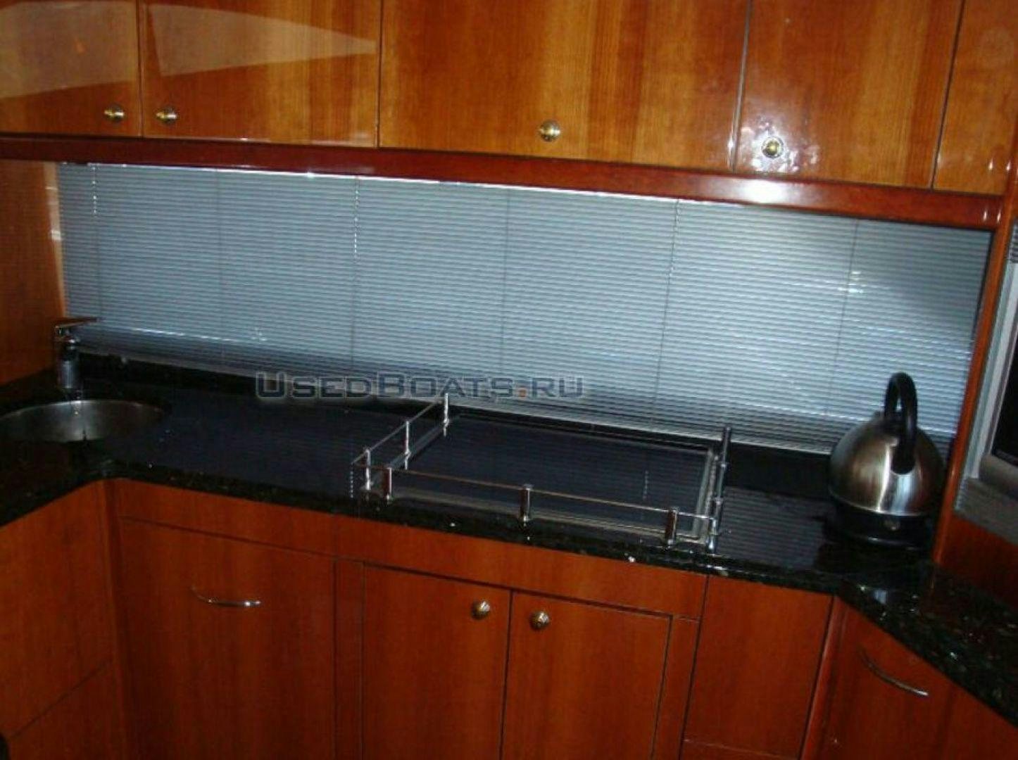 a kitchen with wooden cabinets aboard PURA VIDA Yacht for Sale