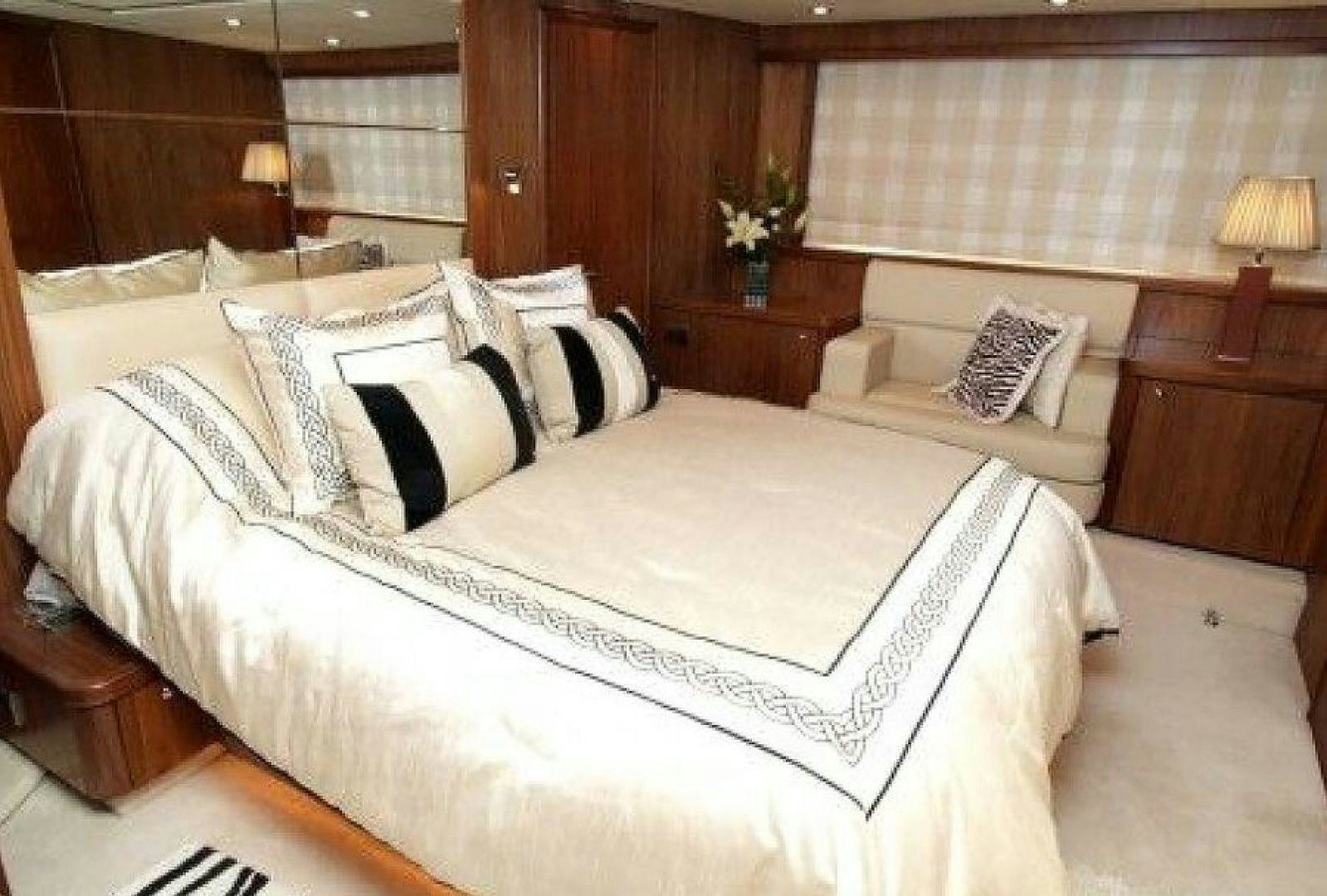 a bed with white sheets aboard PURA VIDA Yacht for Sale