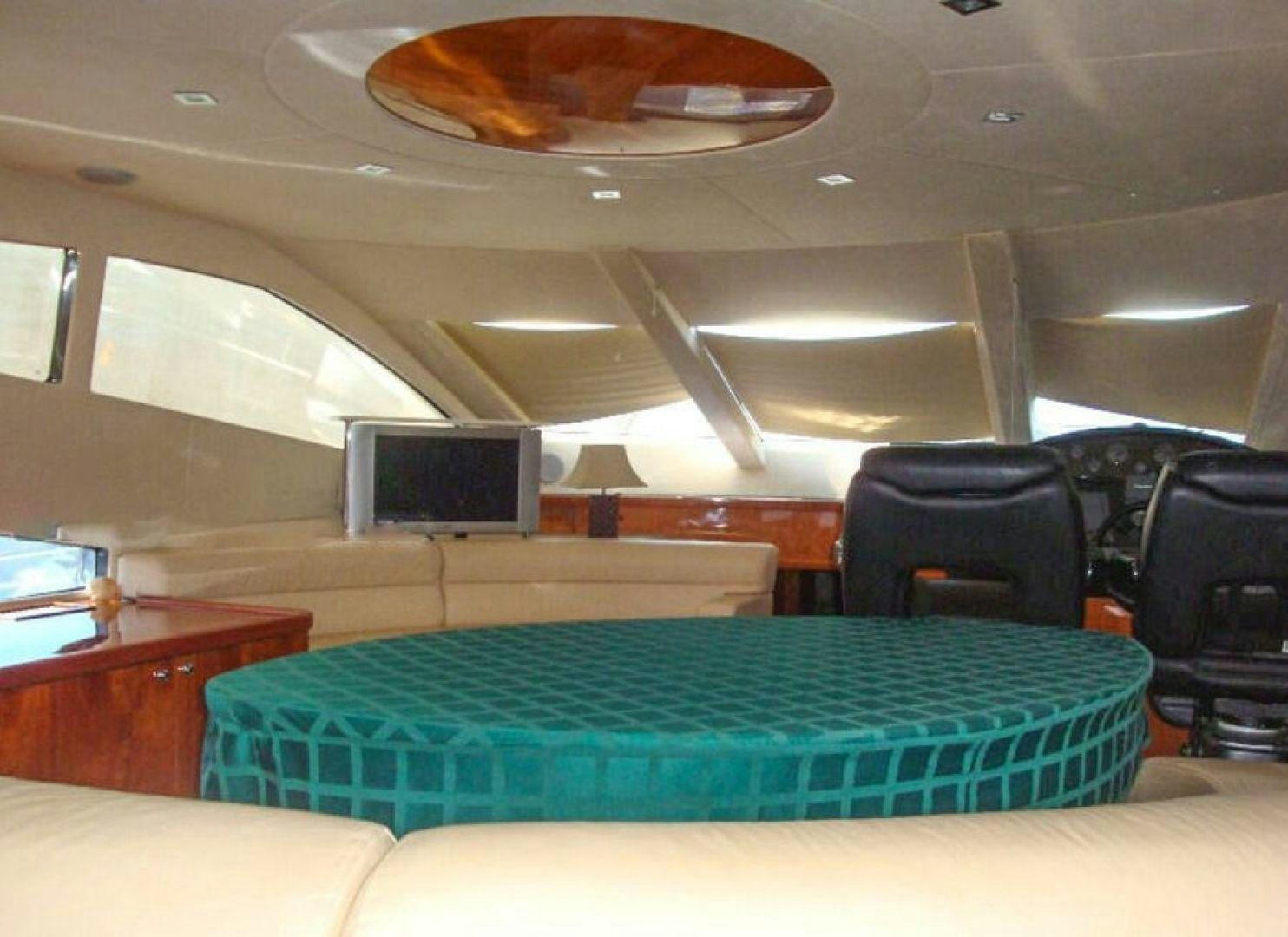 a room with a table and chairs aboard PURA VIDA Yacht for Sale