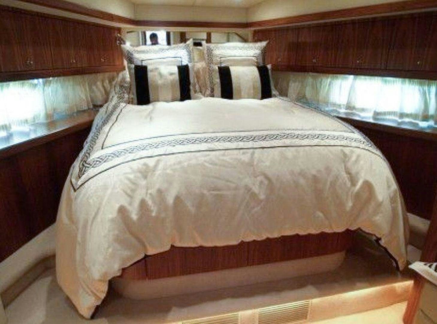 a bed with white sheets aboard PURA VIDA Yacht for Sale