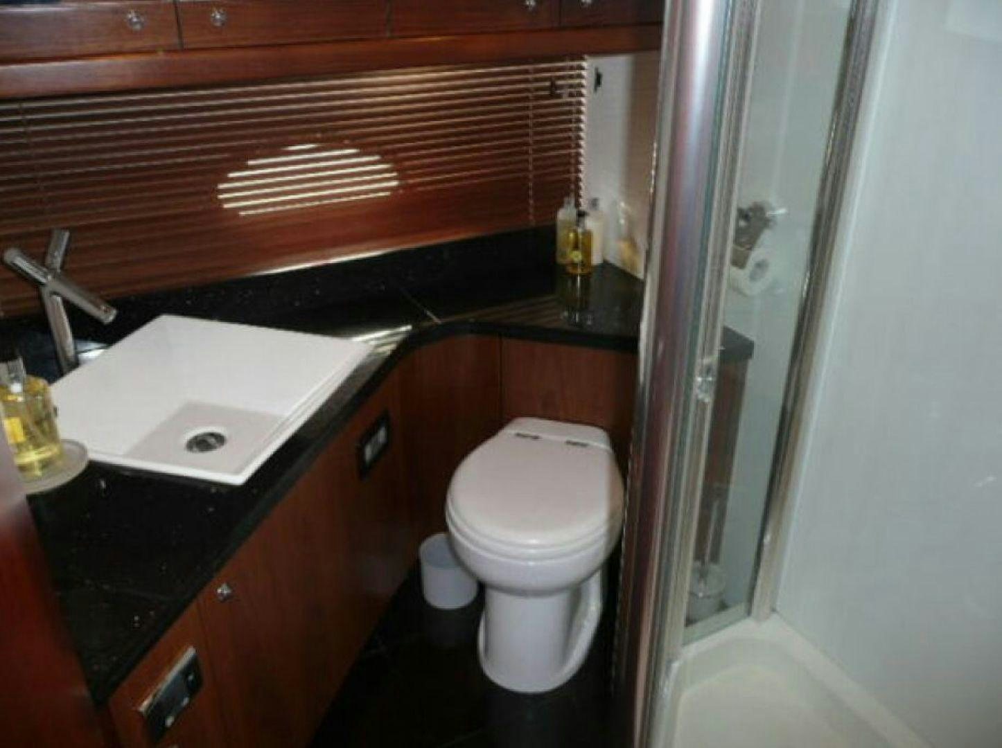 a bathroom with a toilet and sink aboard PURA VIDA Yacht for Sale