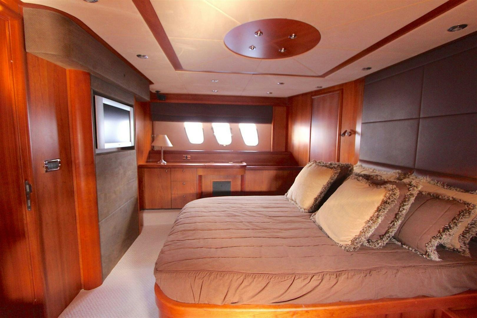a bedroom with a bed and a wood closet aboard No Name Yacht for Sale