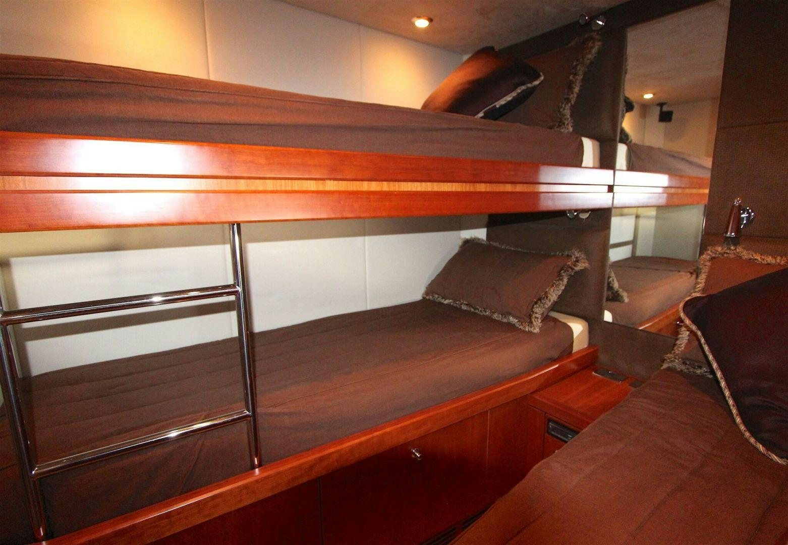 a bed with a wooden frame aboard No Name Yacht for Sale