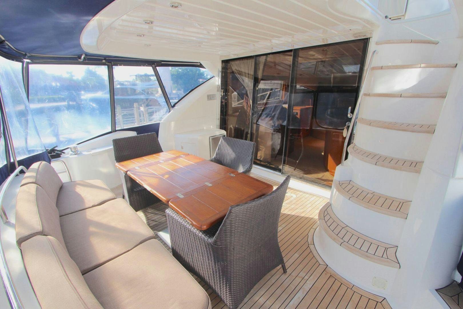 a room with a table chairs and a large window aboard No Name Yacht for Sale