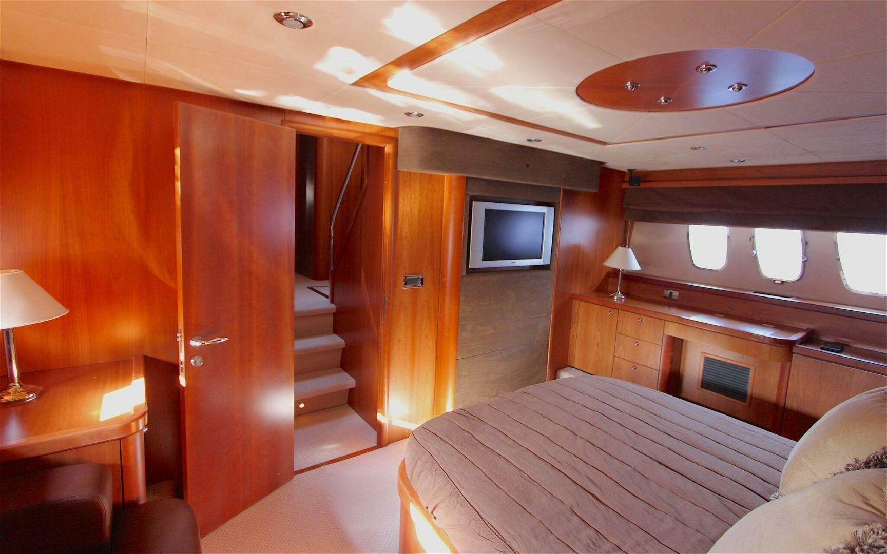 a room with a bed and a television aboard No Name Yacht for Sale